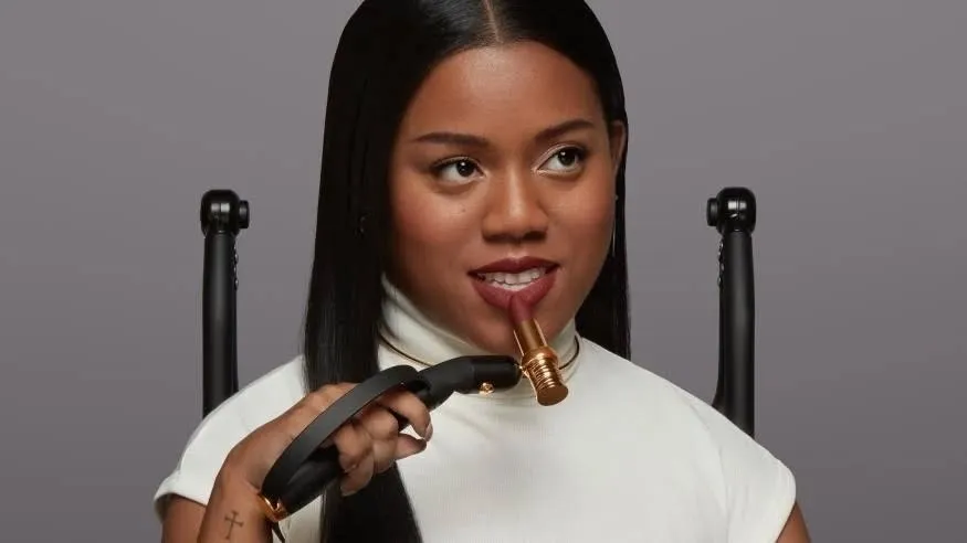 A disabled consumer in beauty using an adaptive beauty tool made by Lancôme