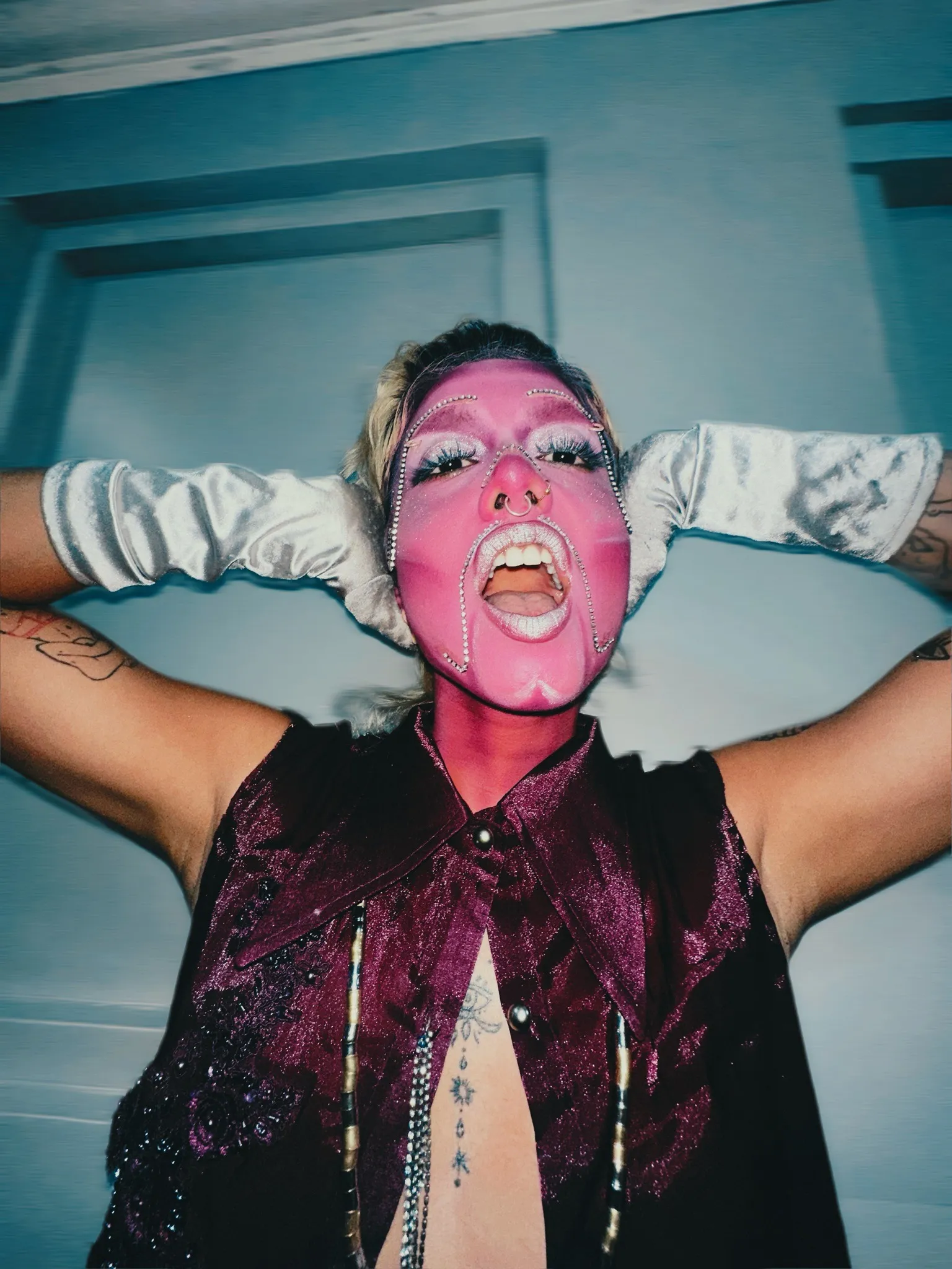 A person decked up in make-up and gloves to show transmasculine identity, along with face jewellery, poses for the camera to show the impact of redefining masculinity