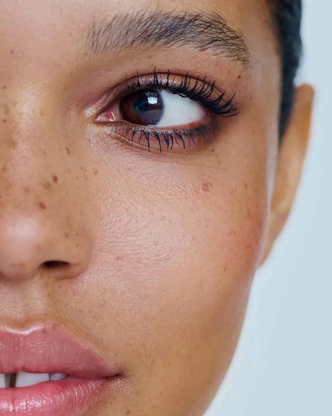 A woman with a full face of make-up, signalling the new beauty industry trends