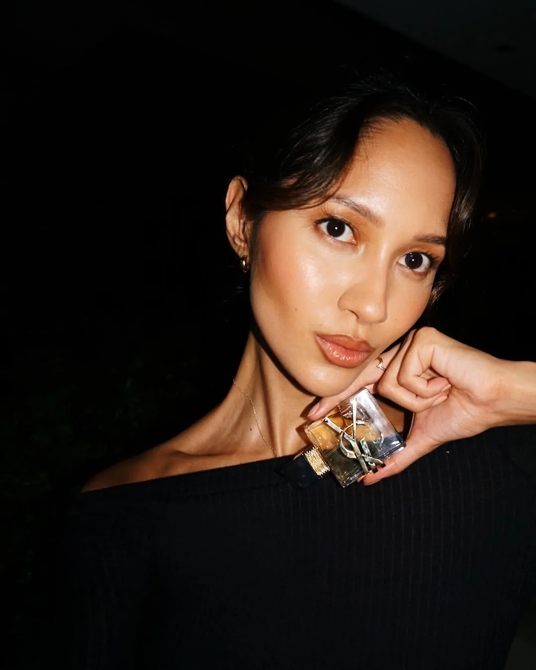 YSL Libre vanilla perfume held by model in her hand