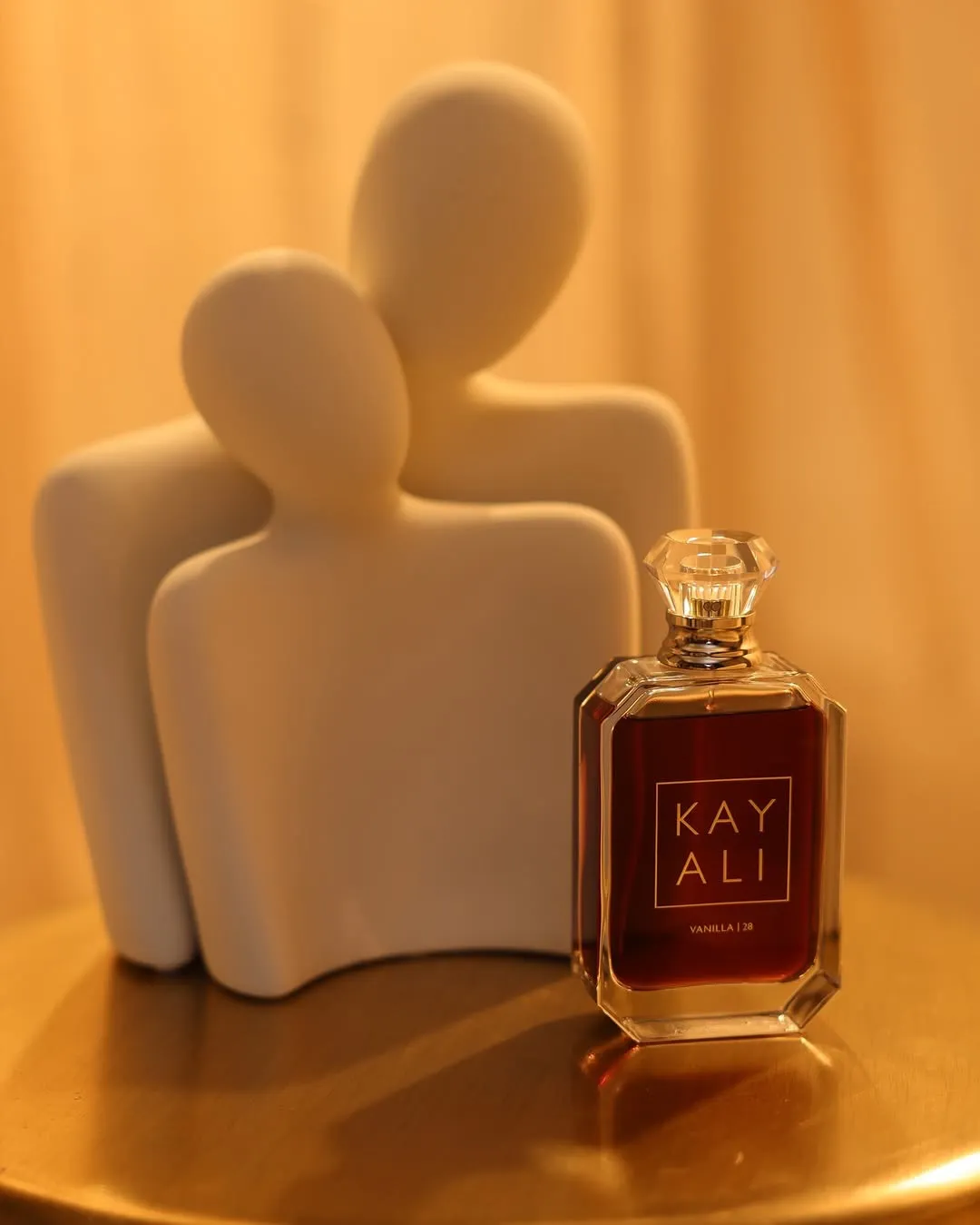 Kayali Vanilla 28 perfume placed against a marble showpiece