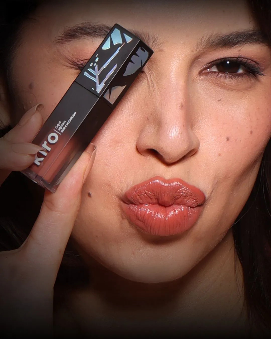 A woman posing with a Kiro beauty creamy matte lipstick