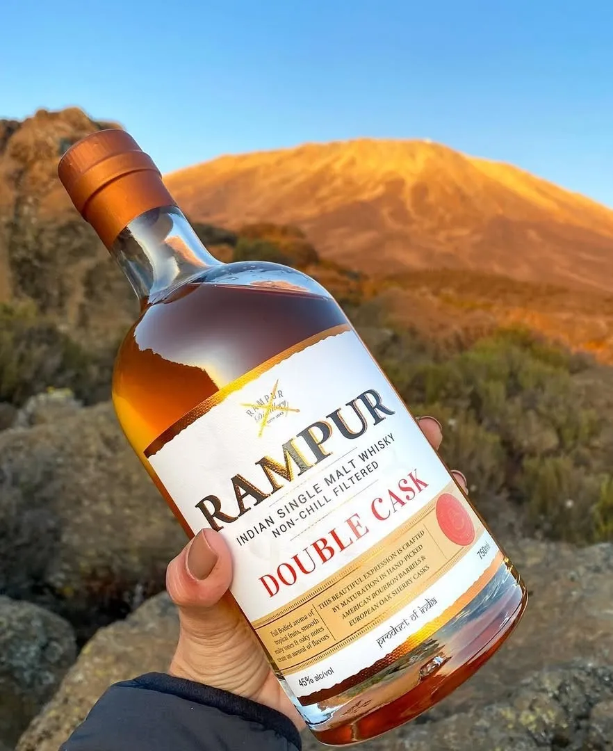 A picture of Rampur single malt whisky against the backdrop of the Rajasthan hills to show the rise of single malt whisky in India as well as Indian single malt worldwide, besides depicting how single malt whisky is made