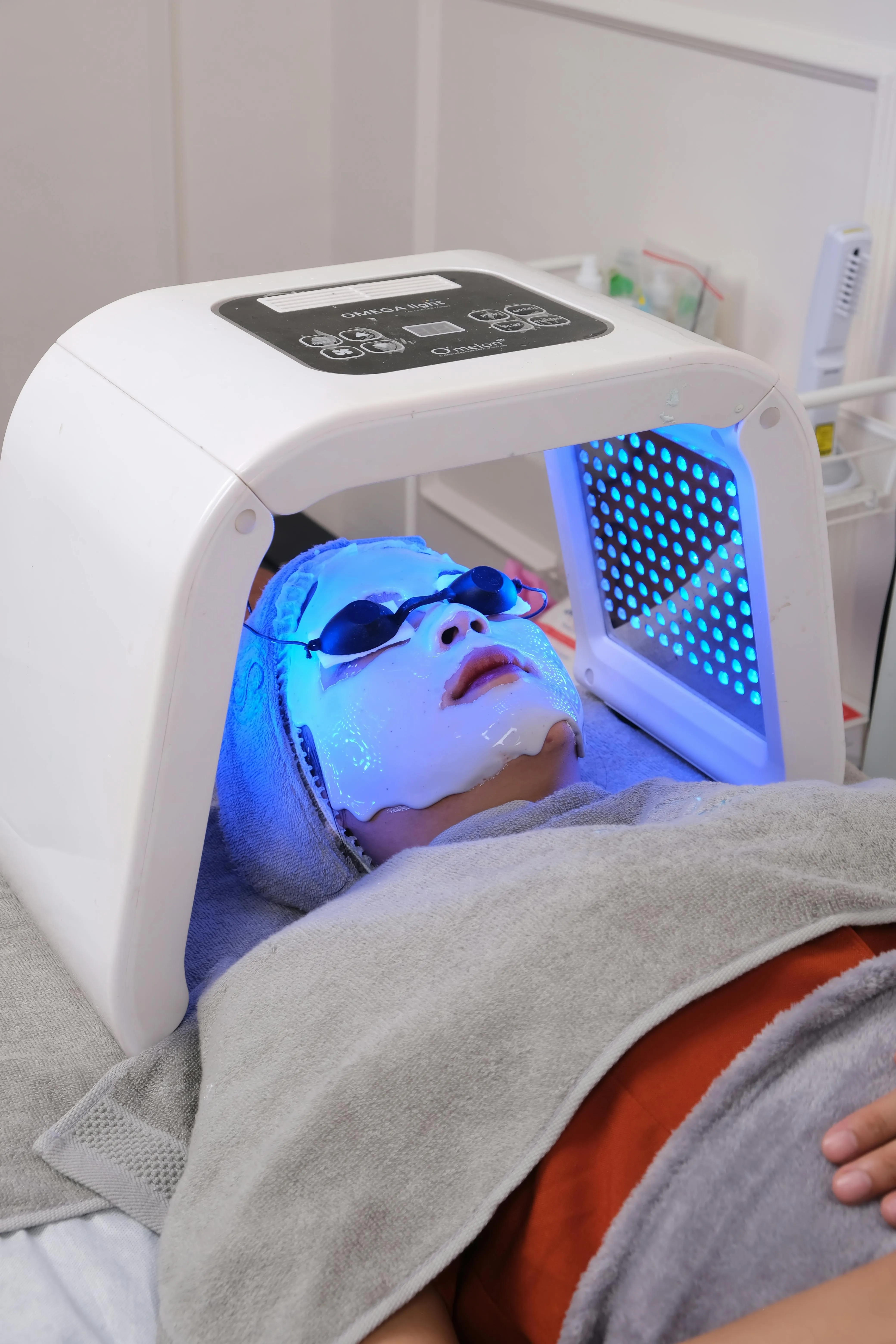A woman at a wellness clinic undergoing LED therapy