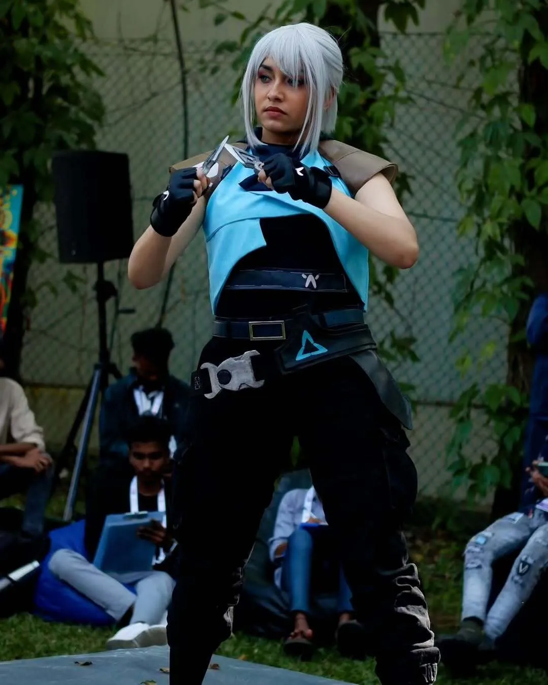A woman dressed up in an anime outfit with blue hair, to depict Asian influence in India via cosplay and Asian culture in India like anime, besides K-dramas in India