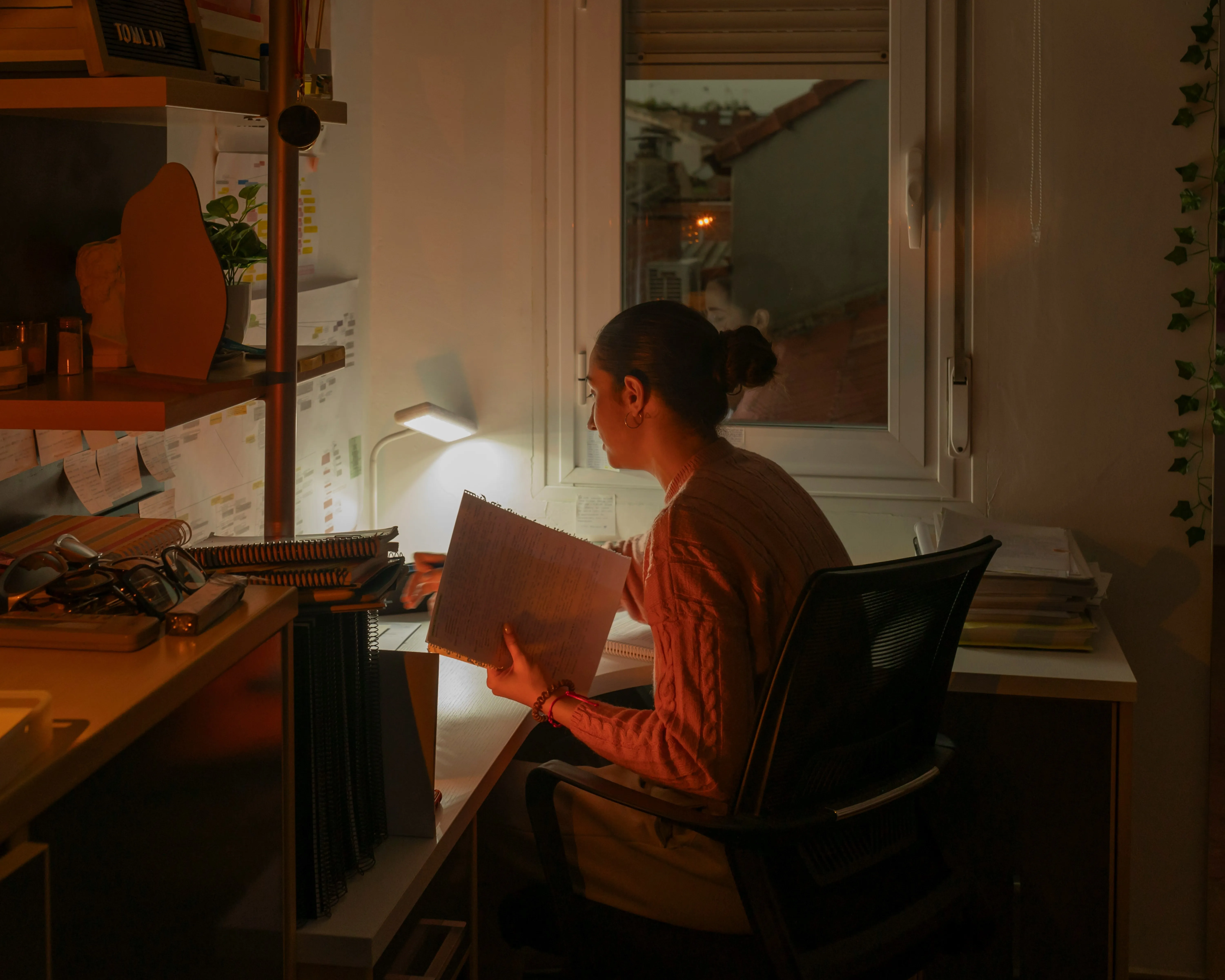 A woman with her type-A personality sitting and working at her office desk