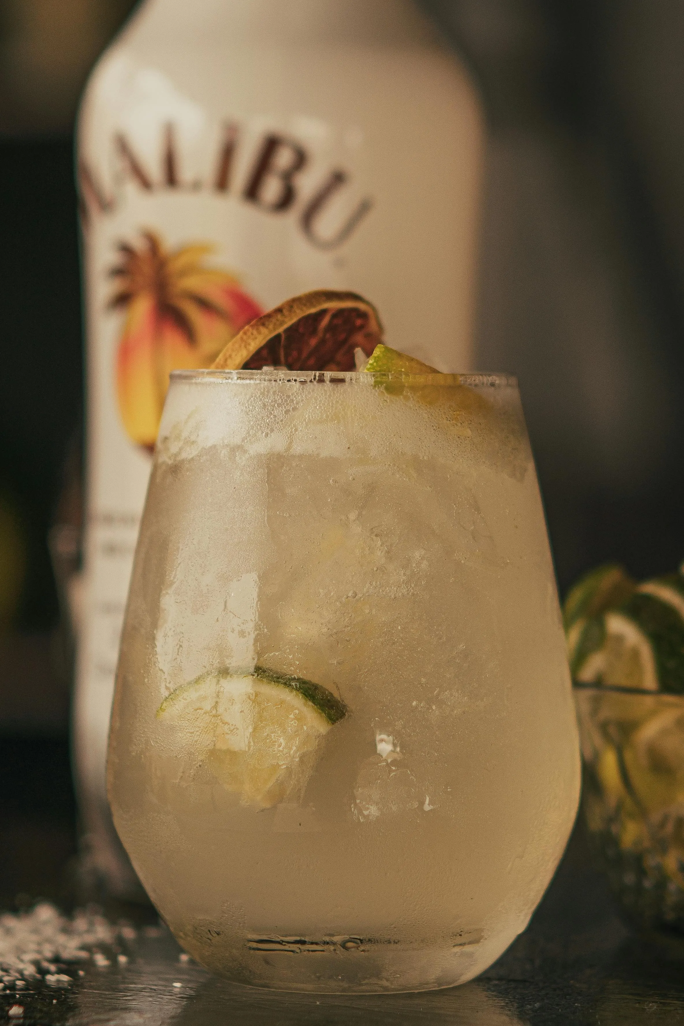 A picture of a white cocktail made with a bottle of white rum in the background to show how rum for cocktails India work as well as how India has gone beyond imported rum India even when it comes to rum gifting India