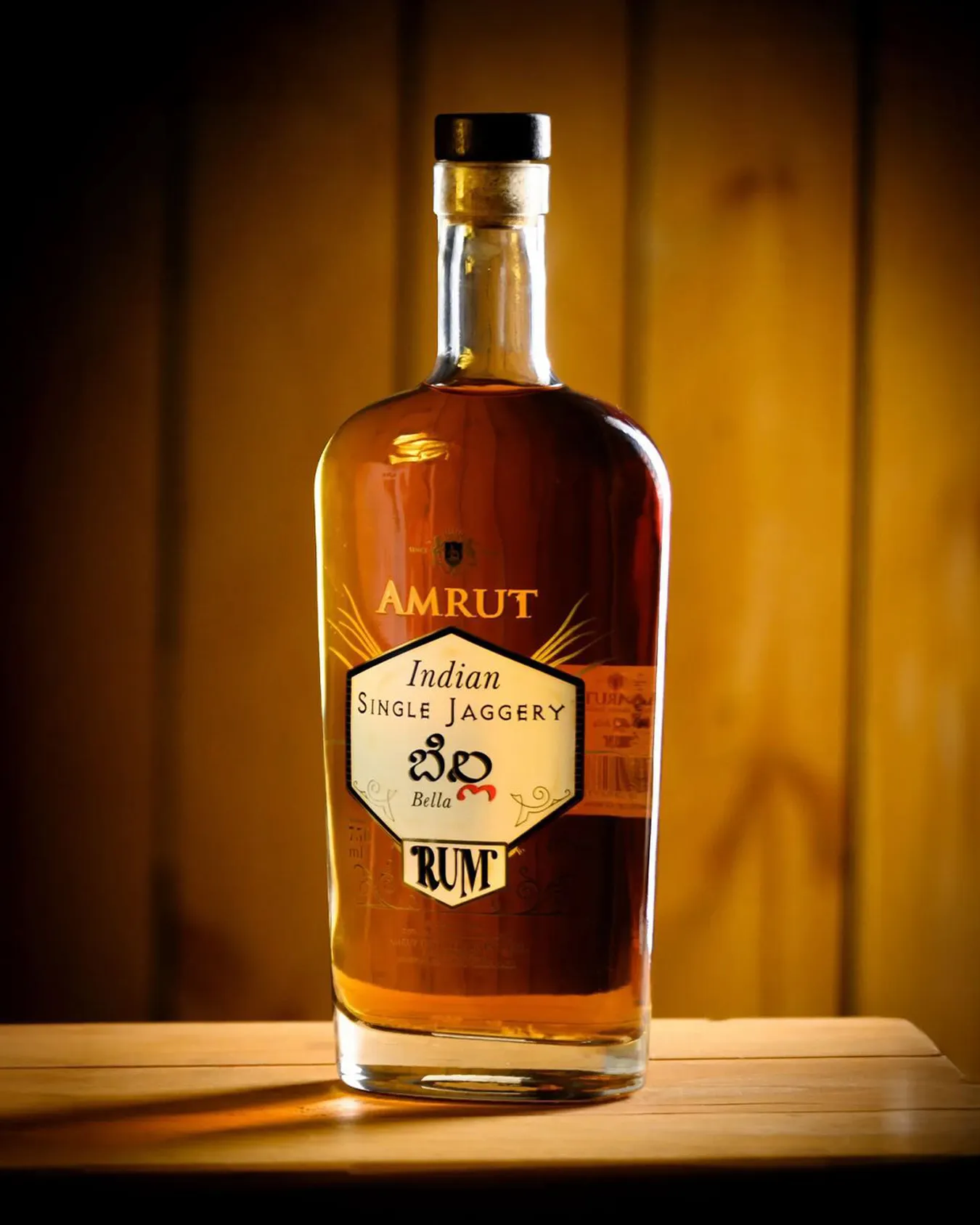 A picture of a bottle of Amrut Indian single jaggery rum to depict craft rum India and the best dark rum India which work for rum gifting India.