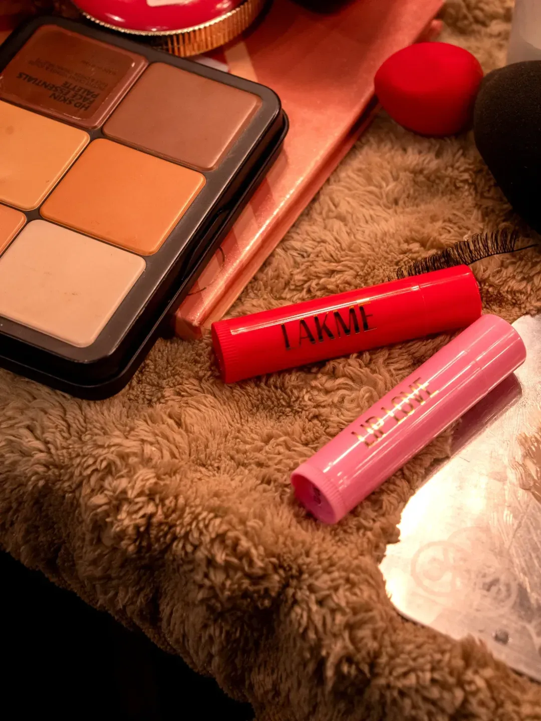 A picture of two lip balms from Lakmē placed on a vanity table