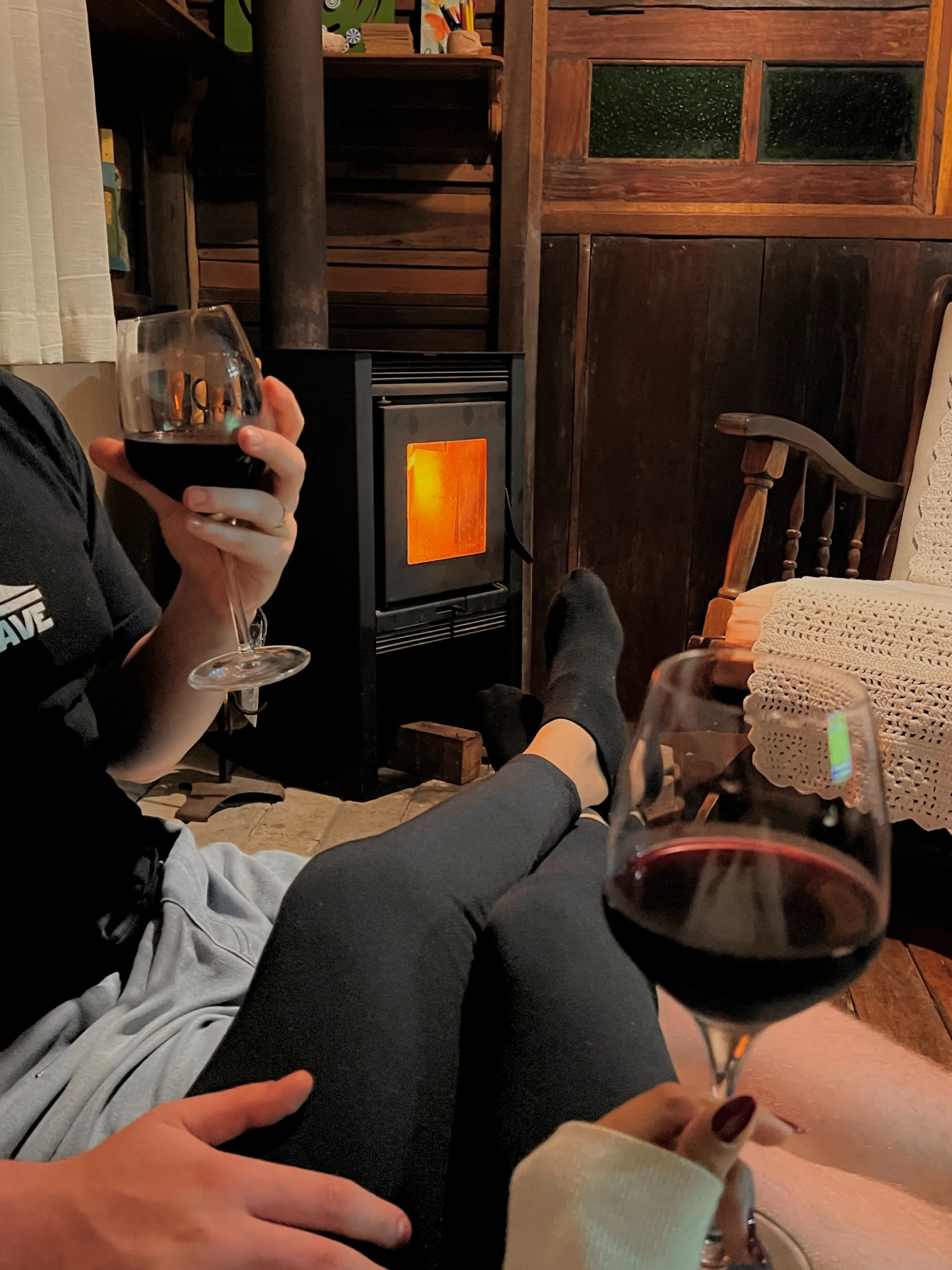 A picture of two people sitting with glasses of red wine to show how cushioning in dating works especially in Gen Z relationships during cuffing season India