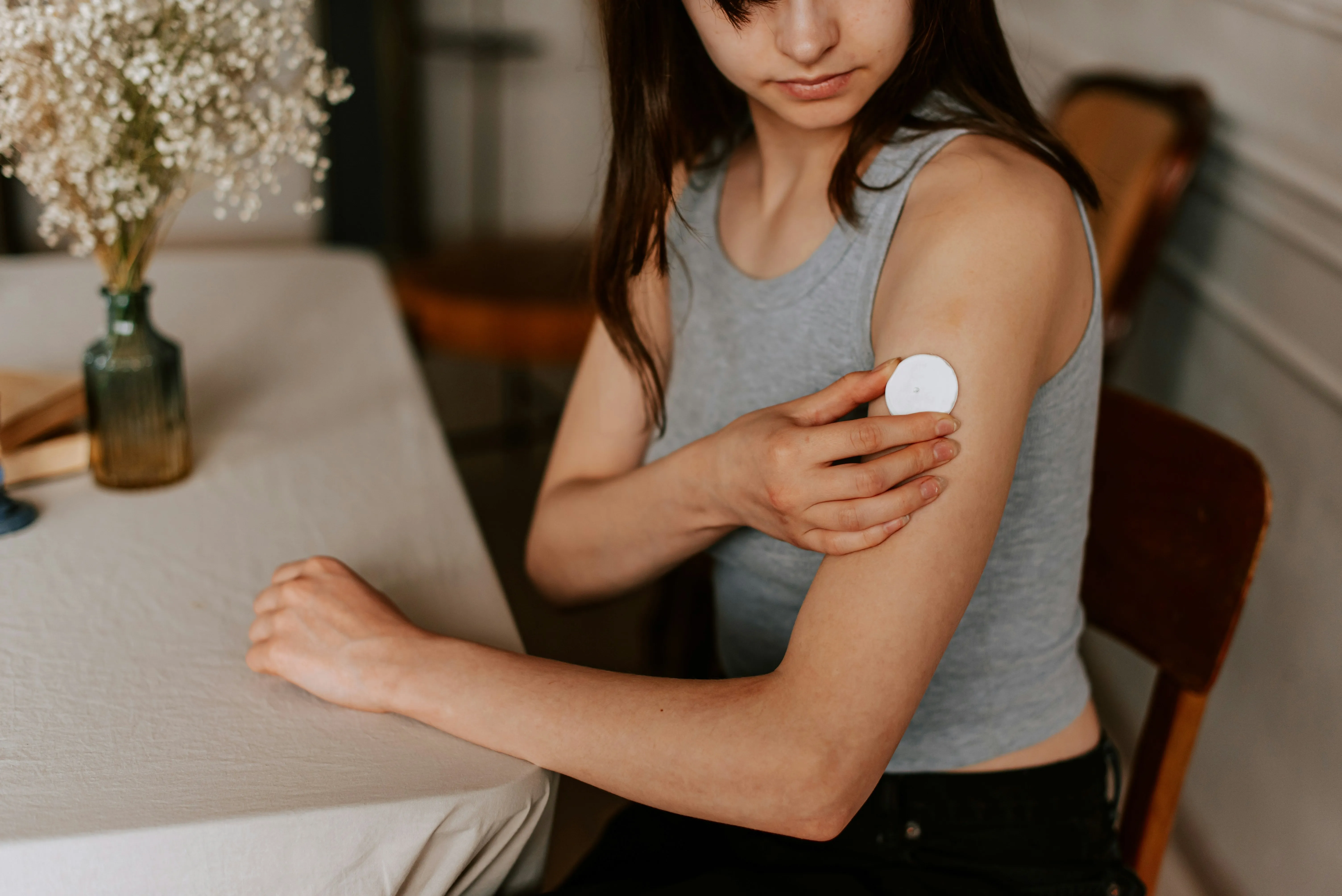 A woman monitoring her health via a device