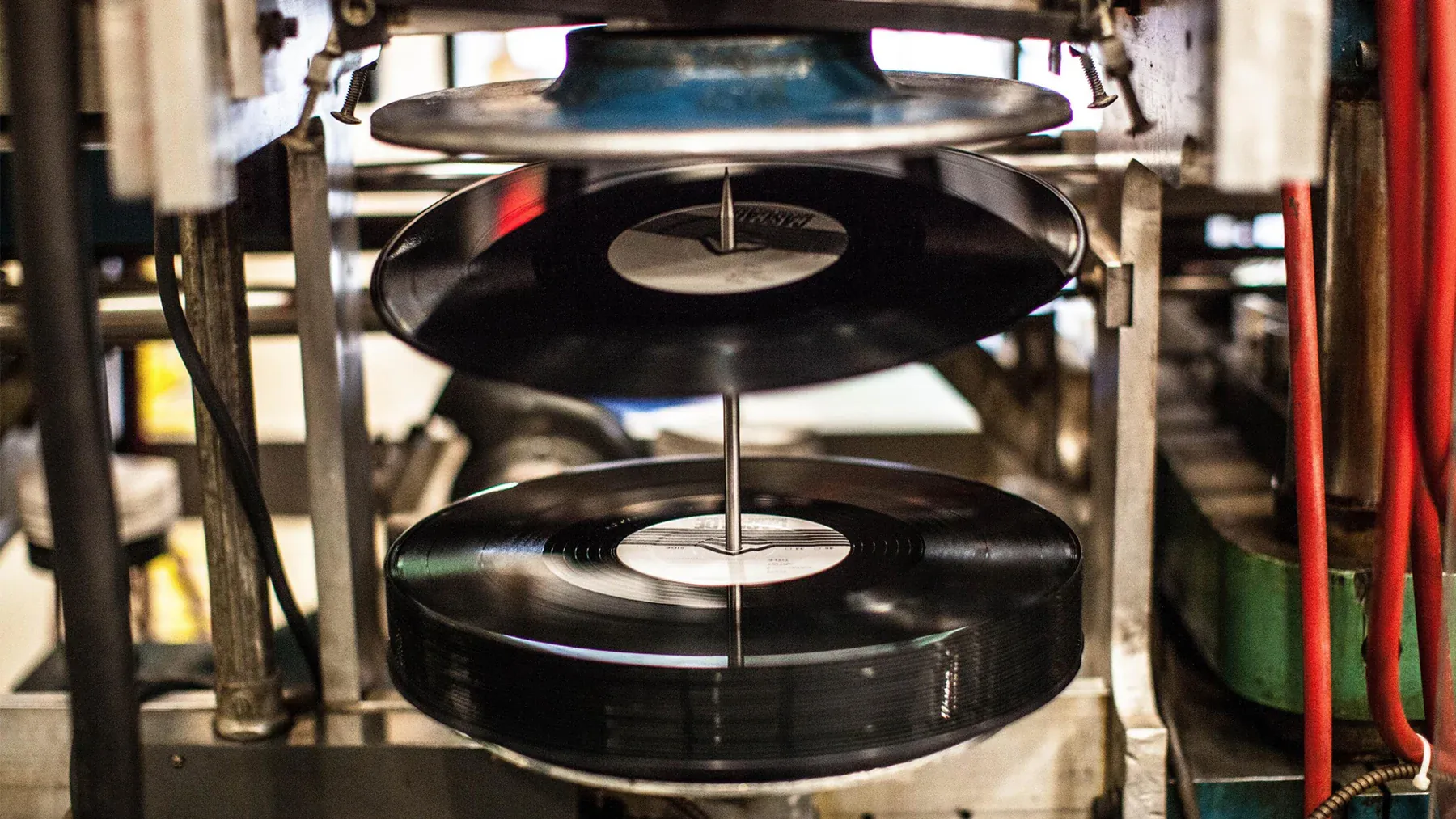 A picture of vinyl pressing India to depict the increasing demand for vinyl records in India, made accessible by vinyl bars India and vinyl cafés India