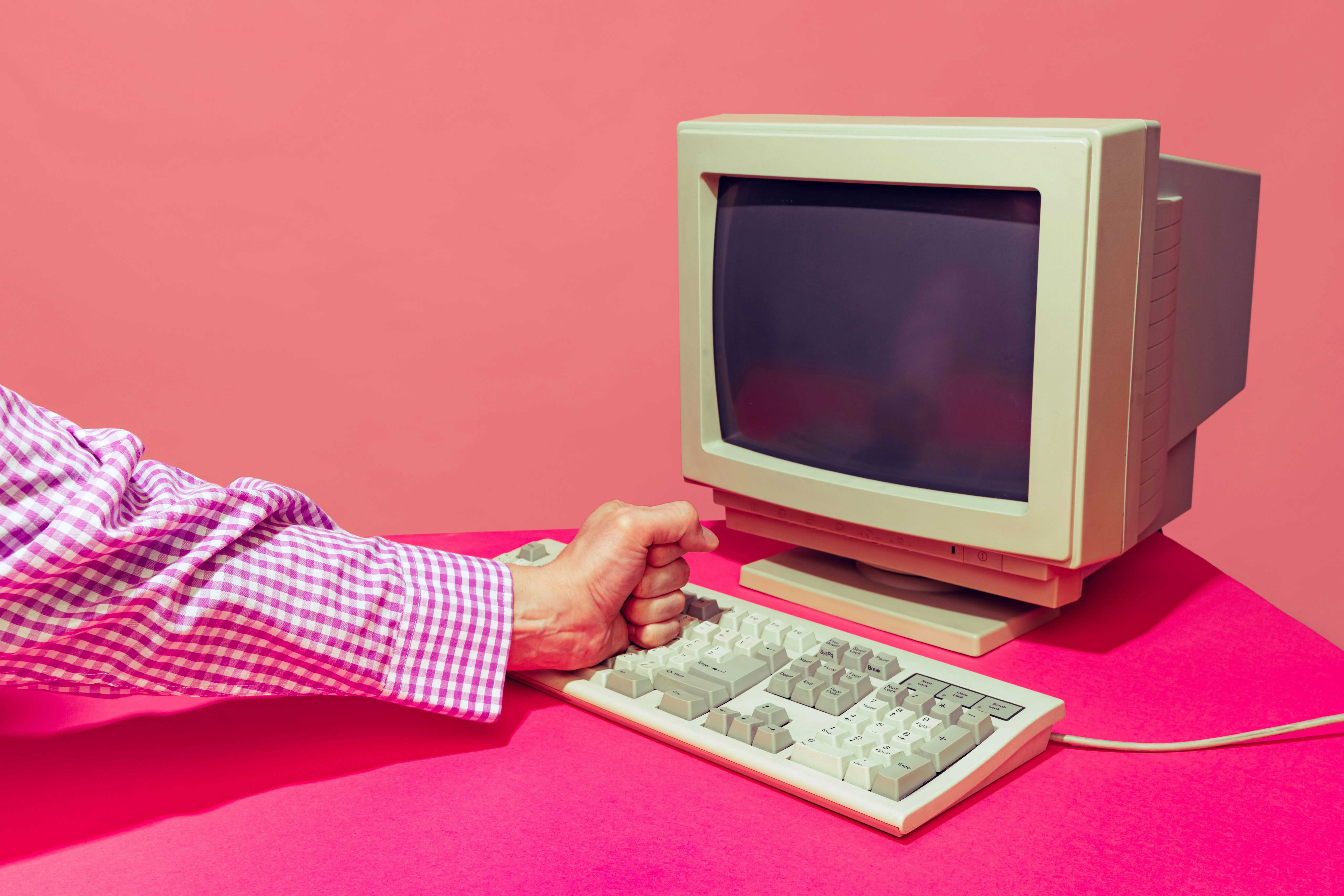 A man using the keyboard and desktop, reflecting the digital divide in India