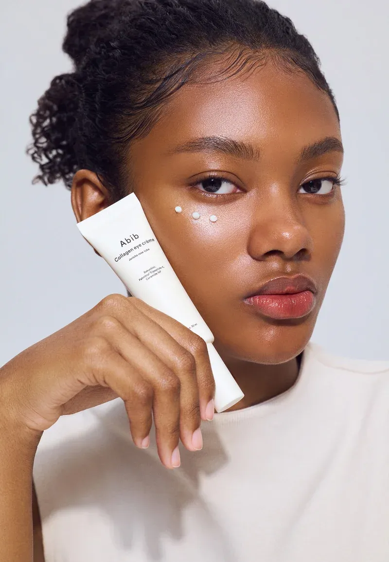 A woman posing with the best under eye cream for fine lines from Abib