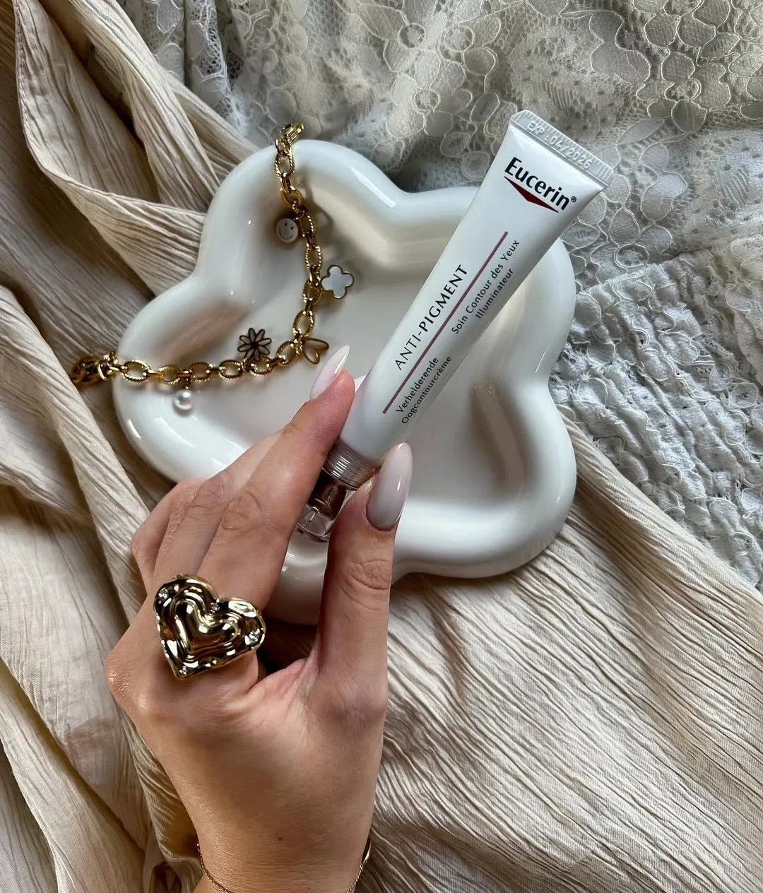 The best under eye cream for dark circles from Eucerin placed in a trinket tray with jewellery