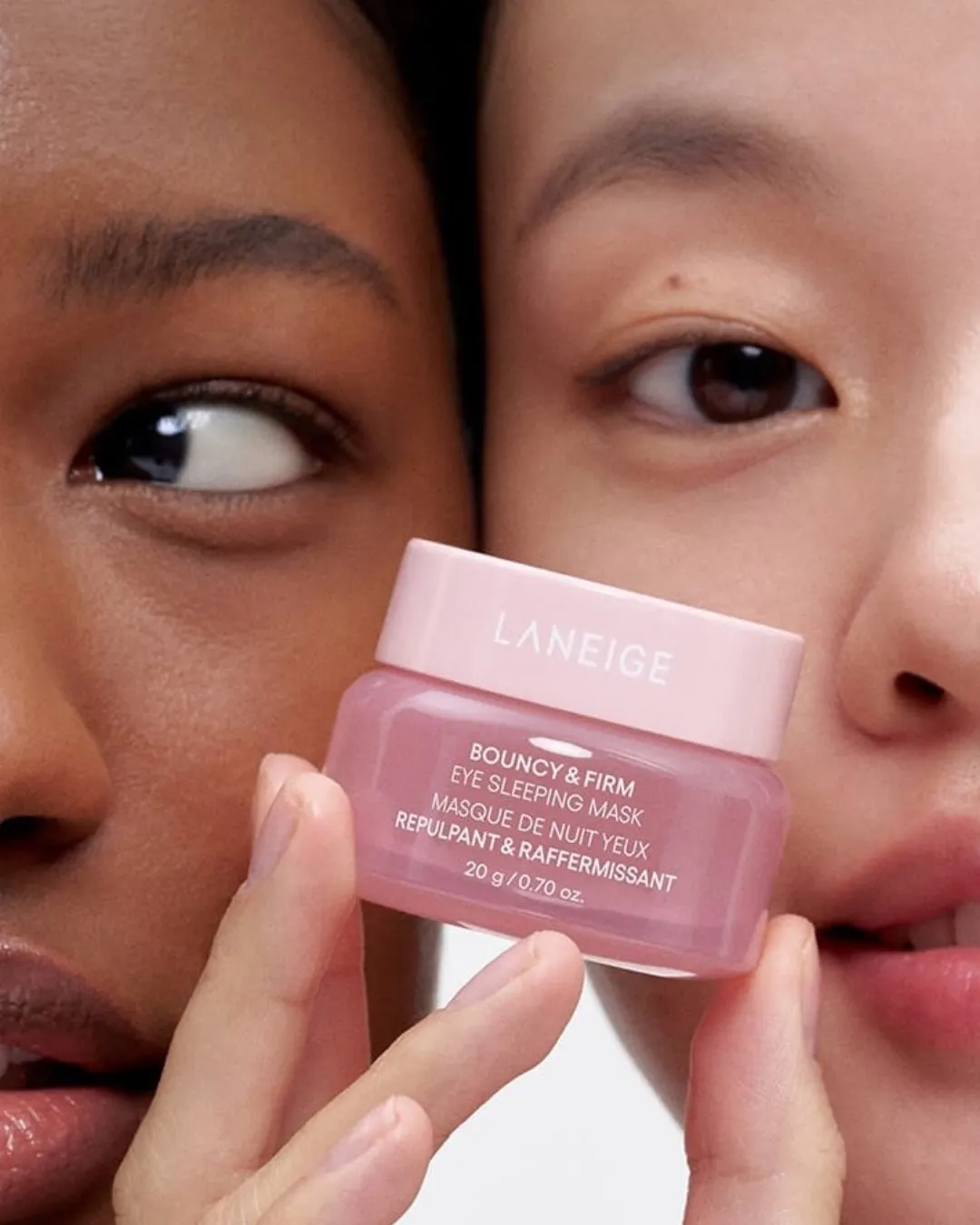 Two women's faces close by with the best under eye cream for bags from Lineage in their hand