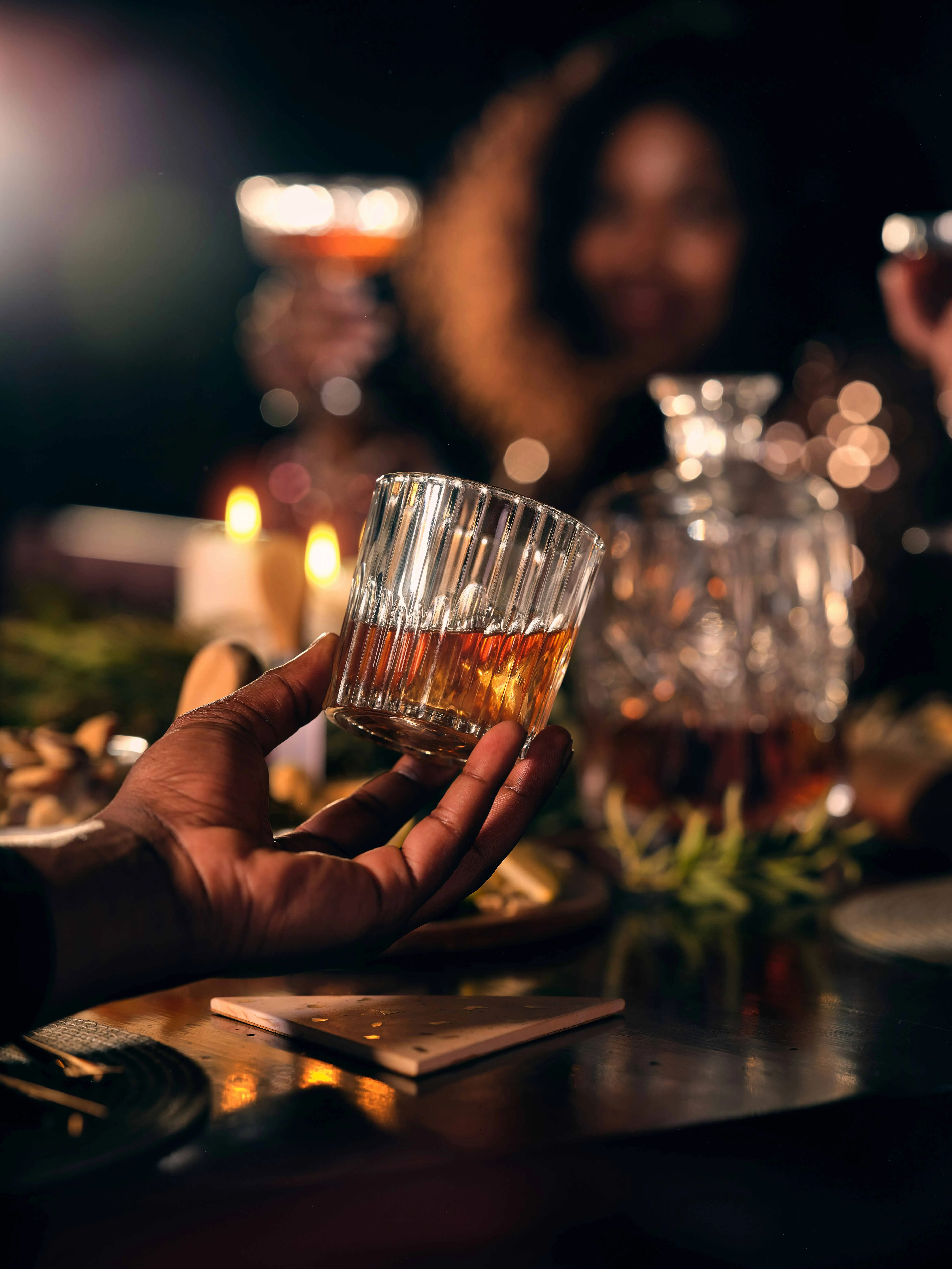 A picture of a person holding a neat drink to show how modern whisky drinking culture  includes whisky and Scotch cocktails in India