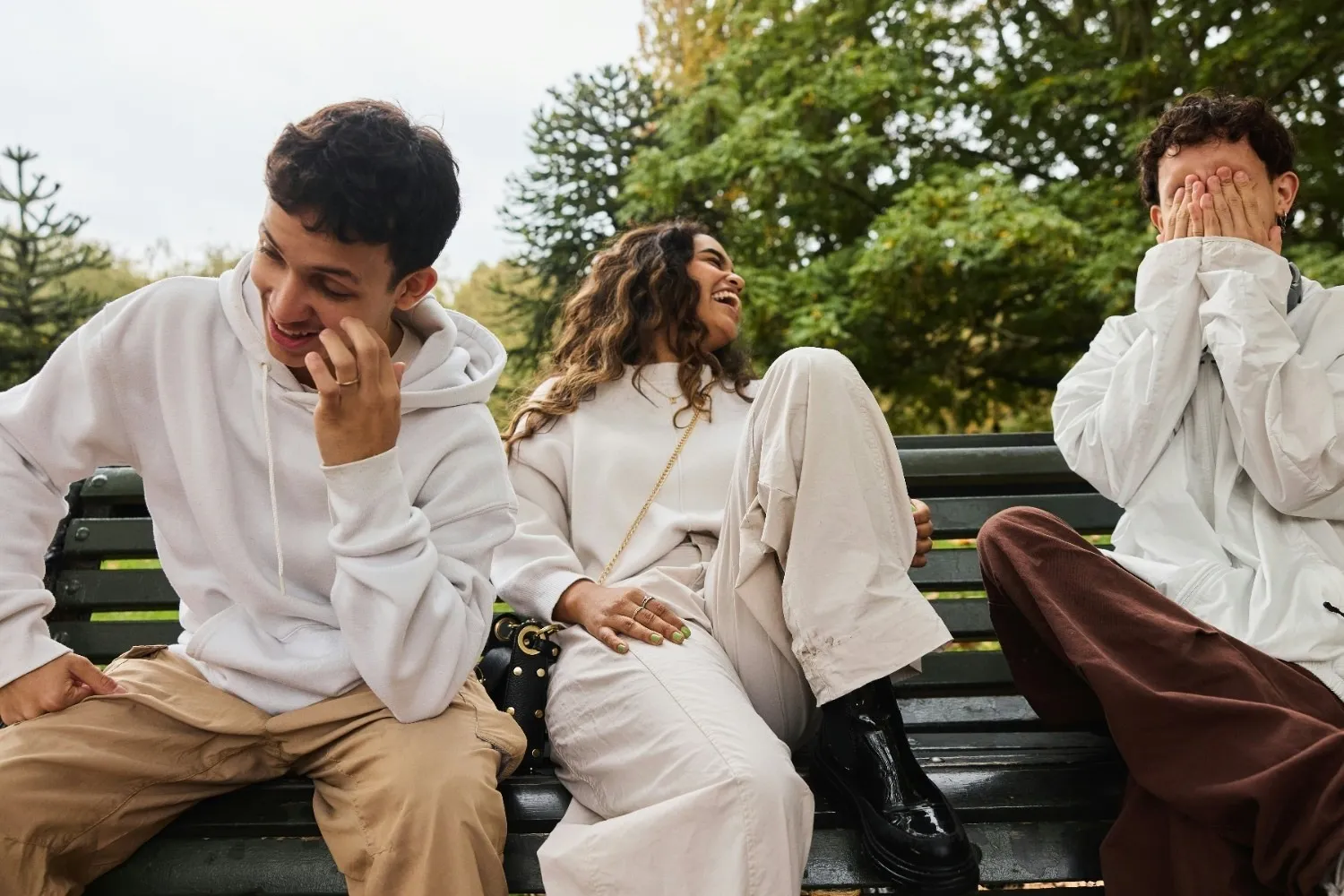 A picture of three people laughing and talking to show the annual horoscope 2026 for Leo as part of the relationship aspect of 2026 astrology predictions.