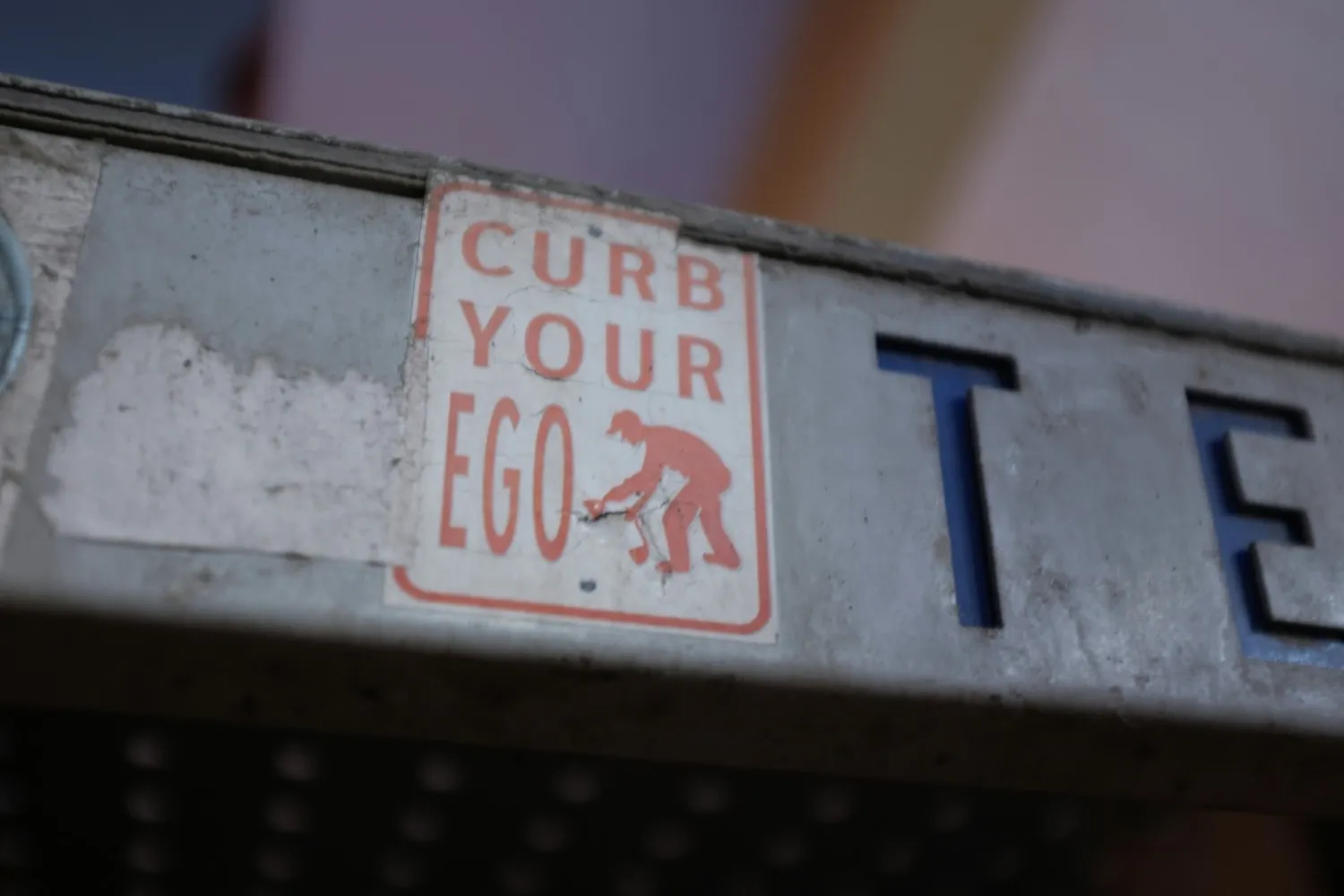 A picture of a signage that says 'curb your ego' to depict Virgo's Annual horoscope 2026 as per planetary transits 2026
