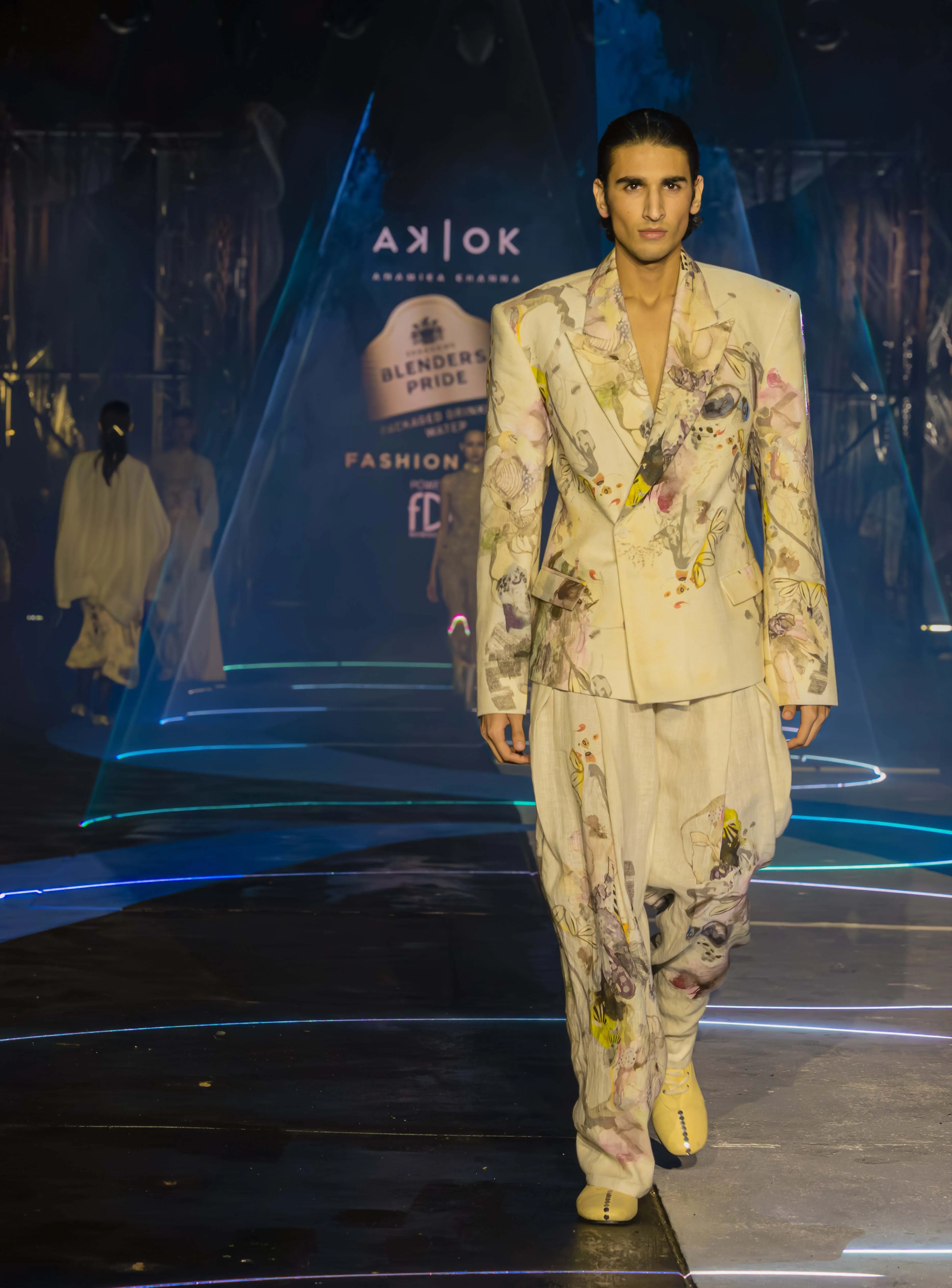 A male model walking on the runway of the Blenders Pride Fashion Tour 2025