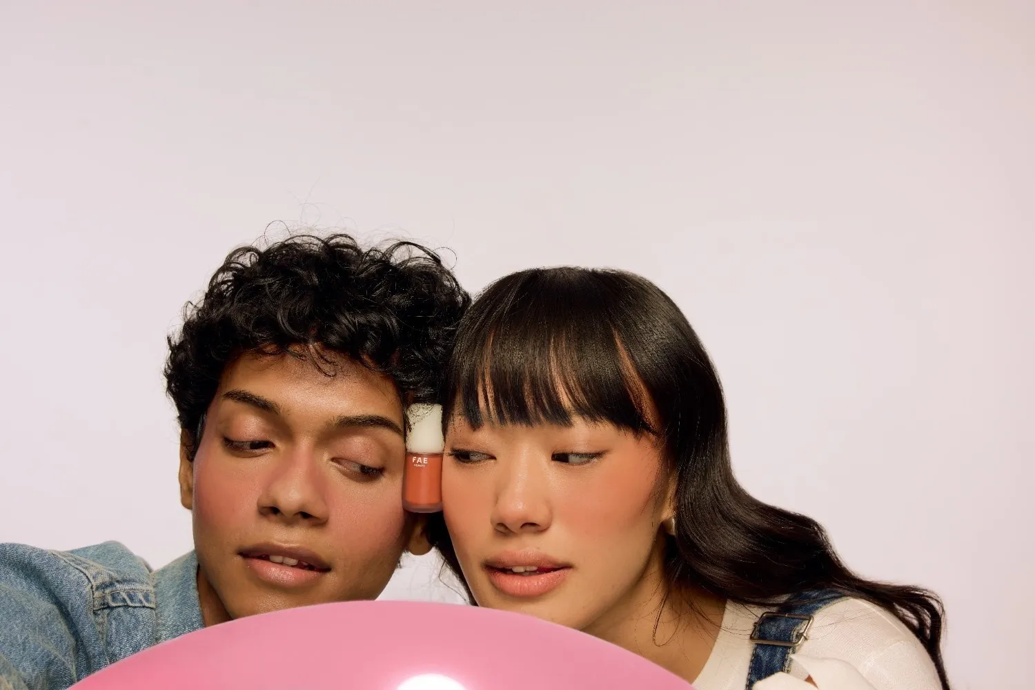 A male and female model in a shoot with a blush from FAE Beauty