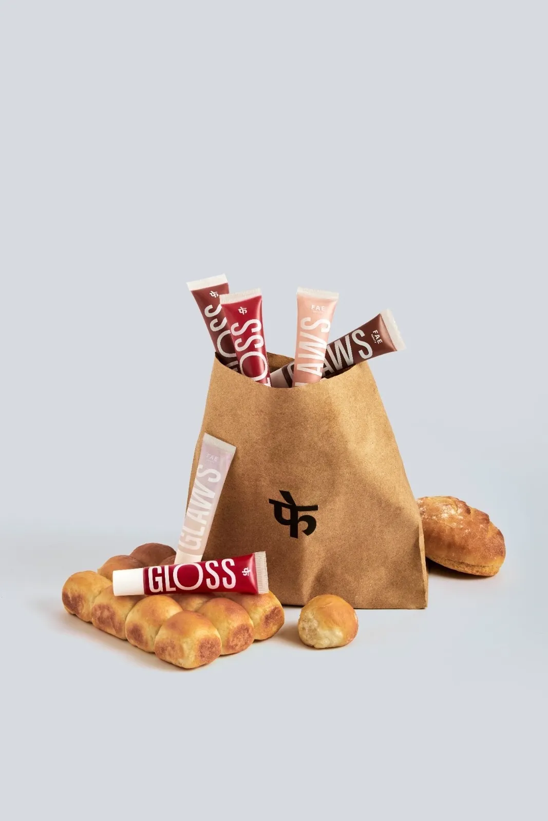 Lip gloss from FAE Beauty and bread in a brown paper bag