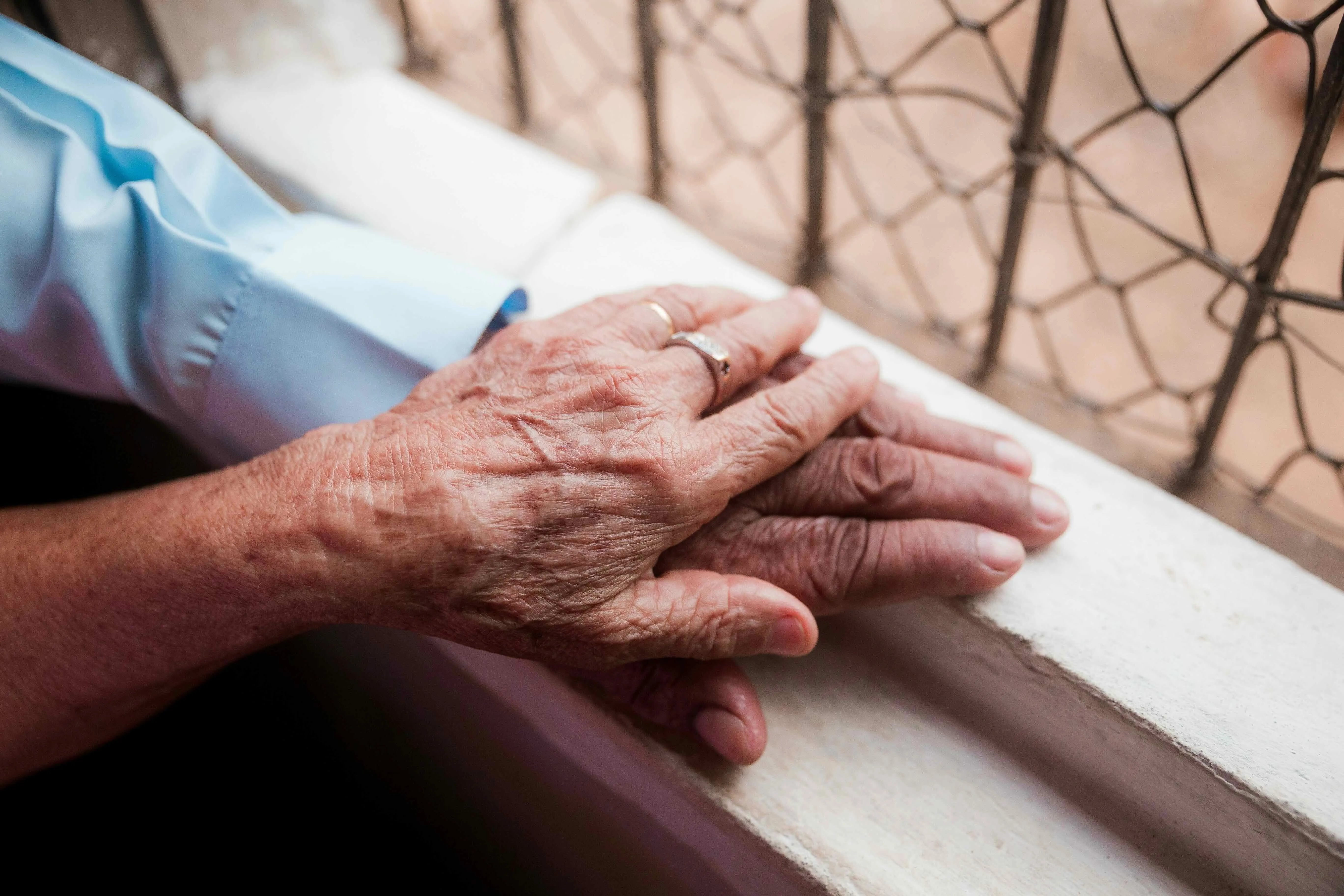A picture of two elderly people's hands to depict queer ageing in India, queer companionship and LGBTQ+ mental health ageing