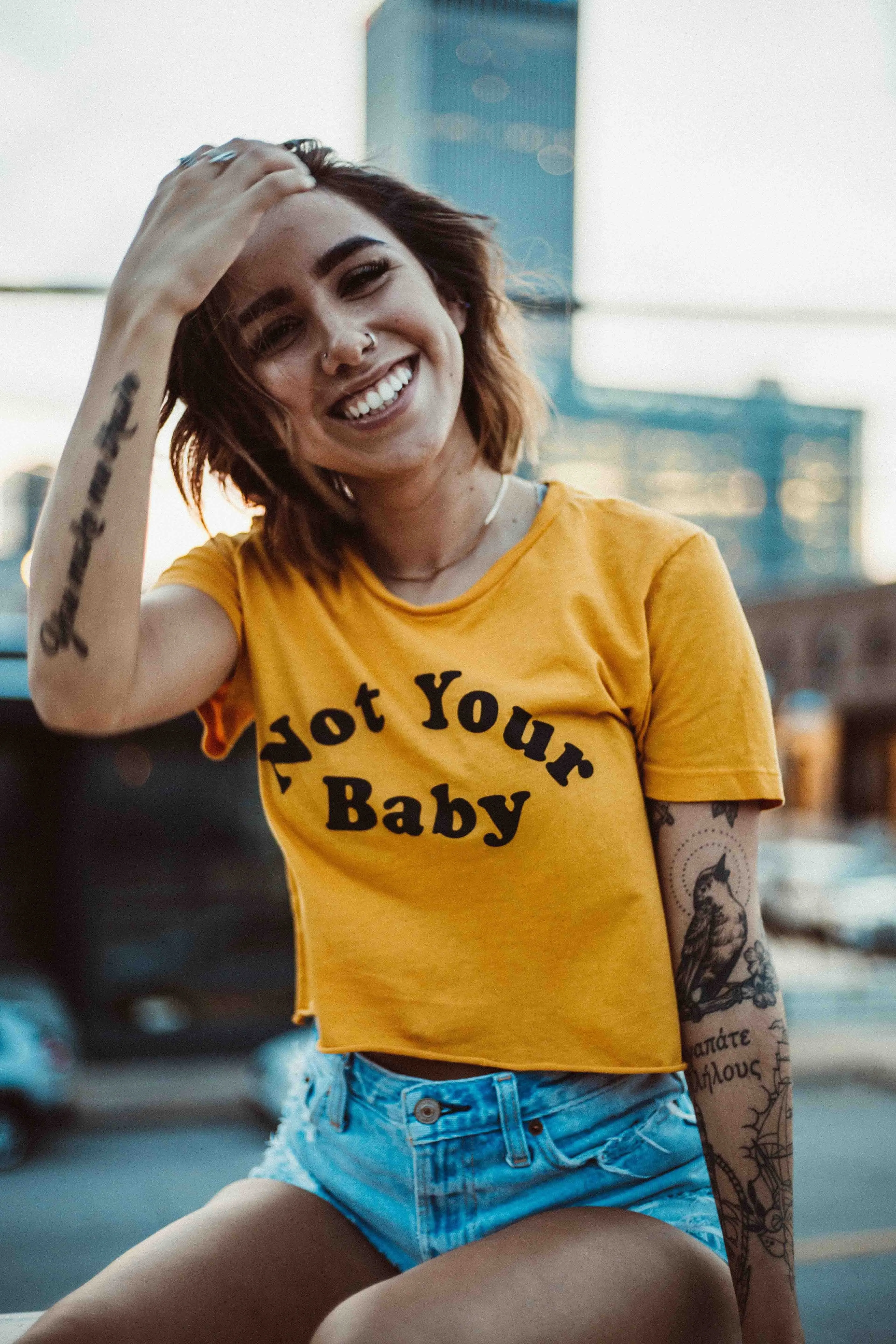 A picture of a woman wearing a t-shirt that reads 'Not Your Baby' to show how flirting in India especially with dating apps India culture leaves the onus on women to clarify any situation