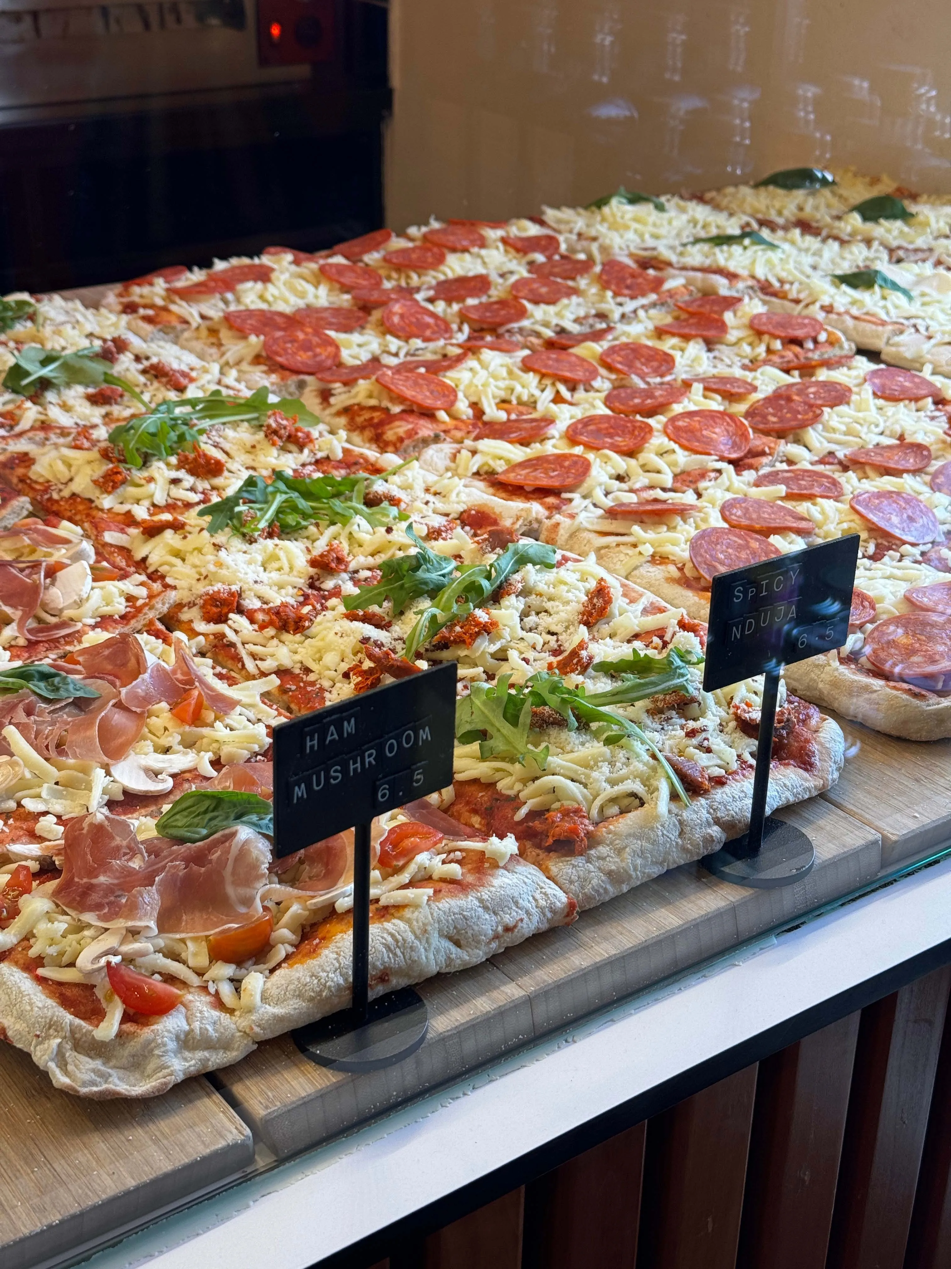 A picture of an array of pizzas, which is one of the main understandings of Italian cuisine in India and authentic Italian food in India but it's actually Indianised Italian food
