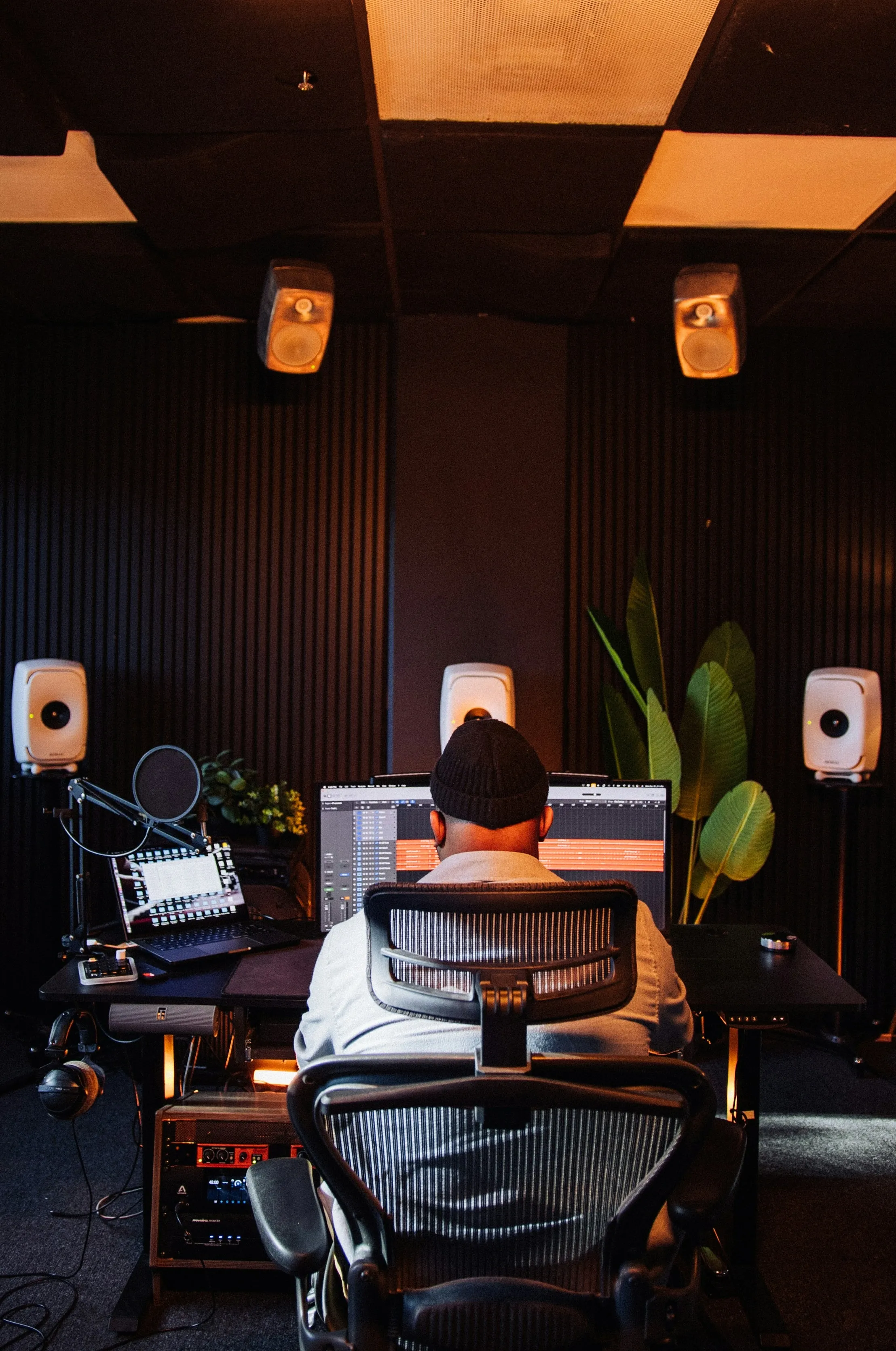 A picture of a person sitting in front of a laptop and making music to show how the business of musicians in India has been impacted by how musicians make money in India and independent musicians in India