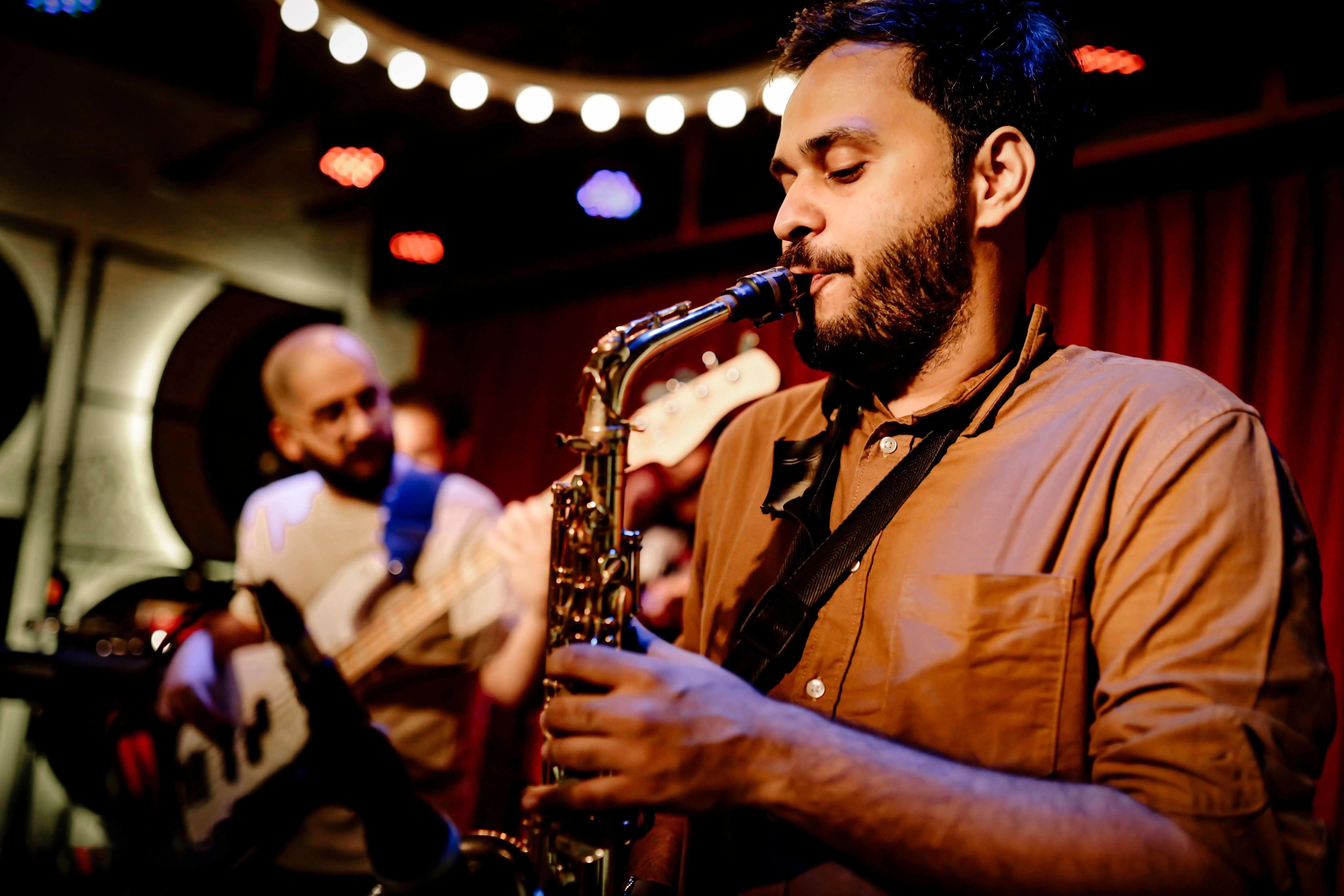 A picture of a saxophone player performing at one of the music festivals in India to show how the business of musicians in India has evolved to incorporate independent musicians in India