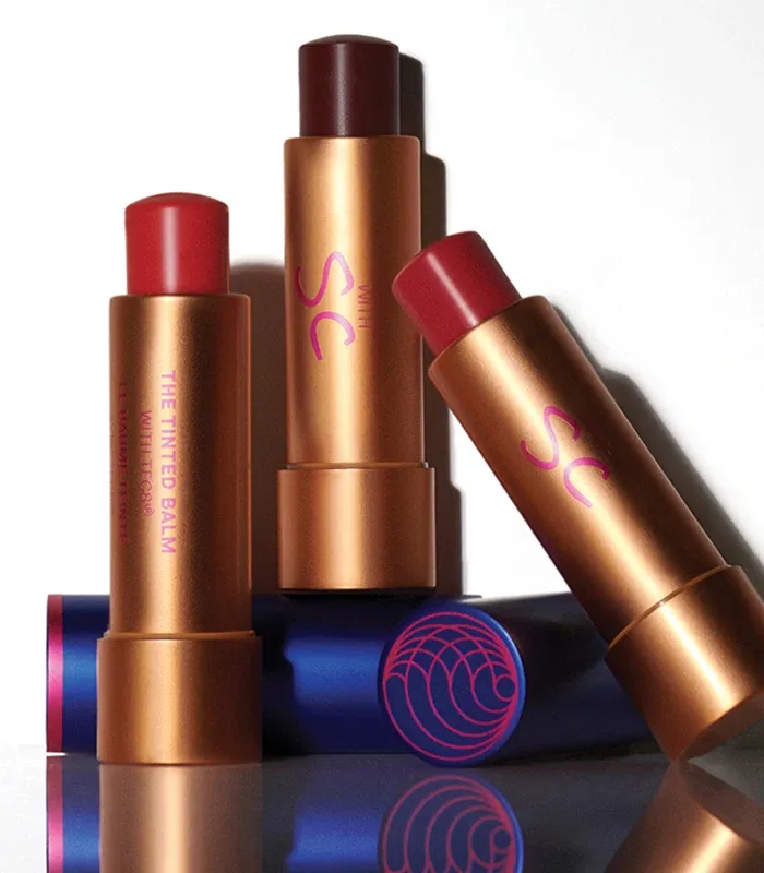 Four best tinted lip balms form Augustinus Bader placed on a table
