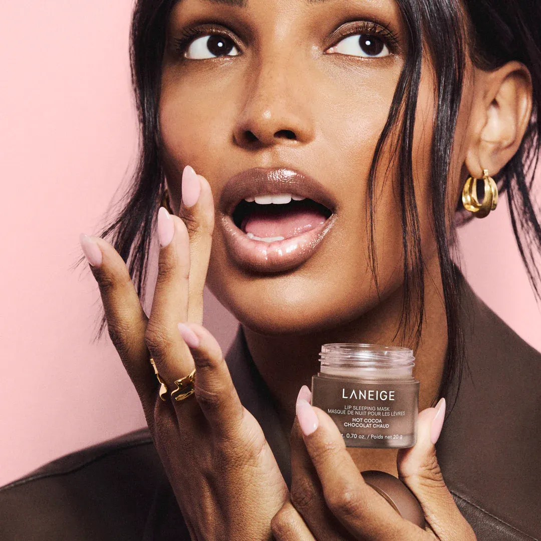 A woman applying Laneige Lip Sleeping Mask for chapped lips
