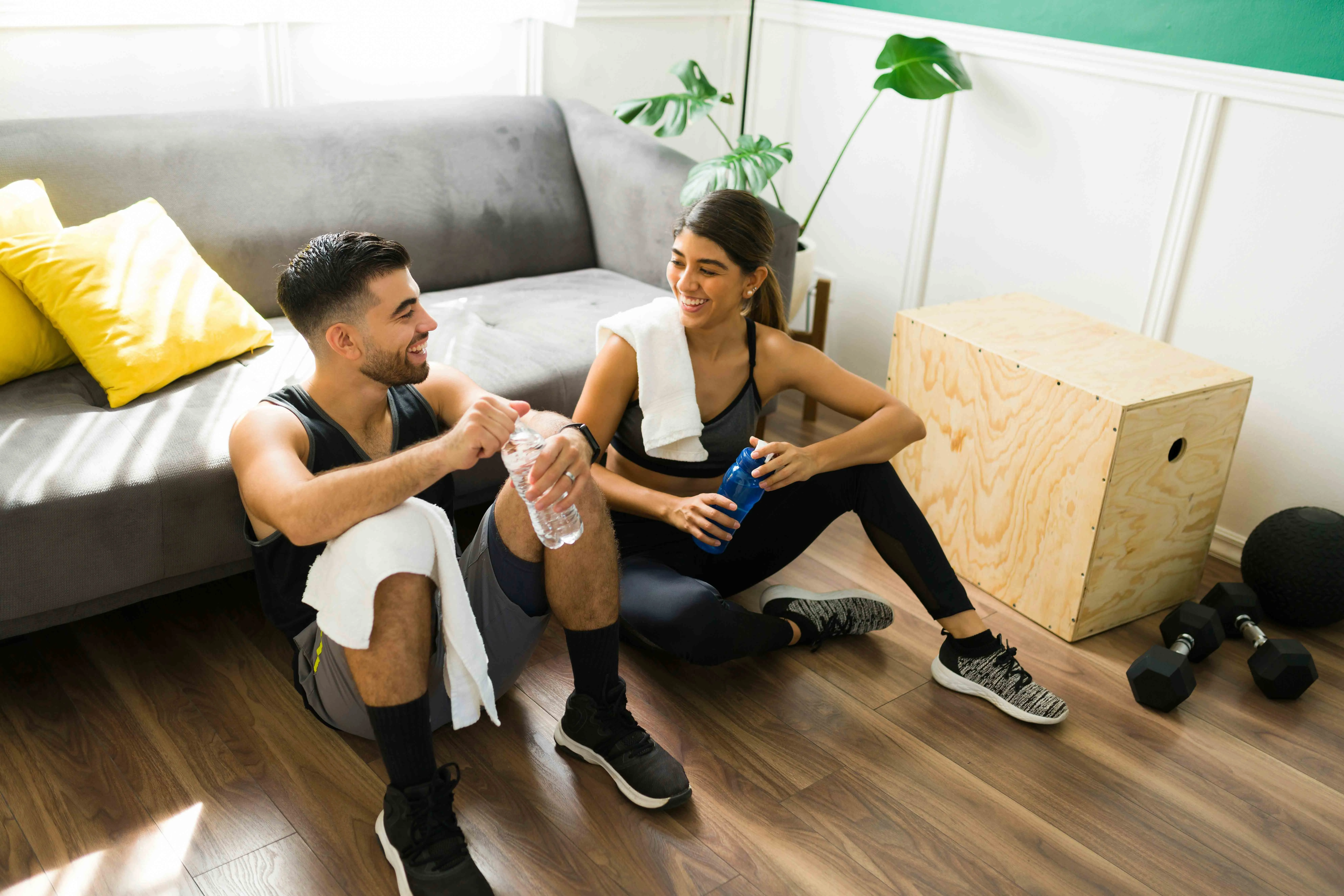 A picture of two partners, a man and woman, sitting together after a workout