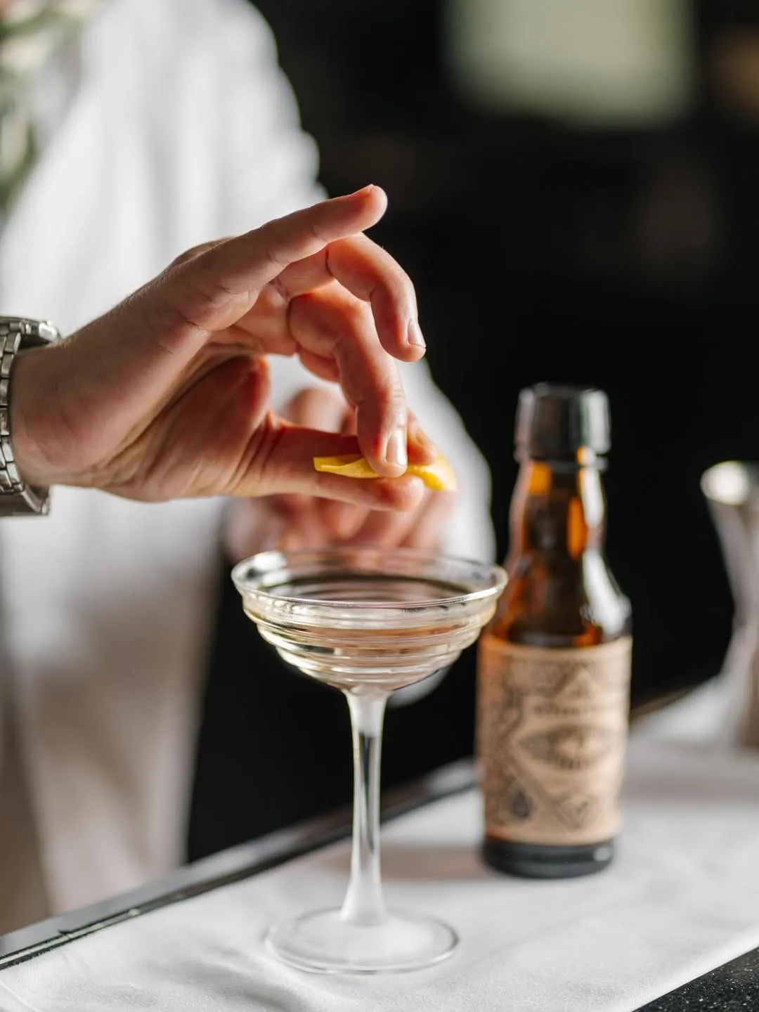 A person using the bitter truth cocktail bitters in India to show the popularity of cocktail bitters in India including craft bitters India in Indian cocktail culture