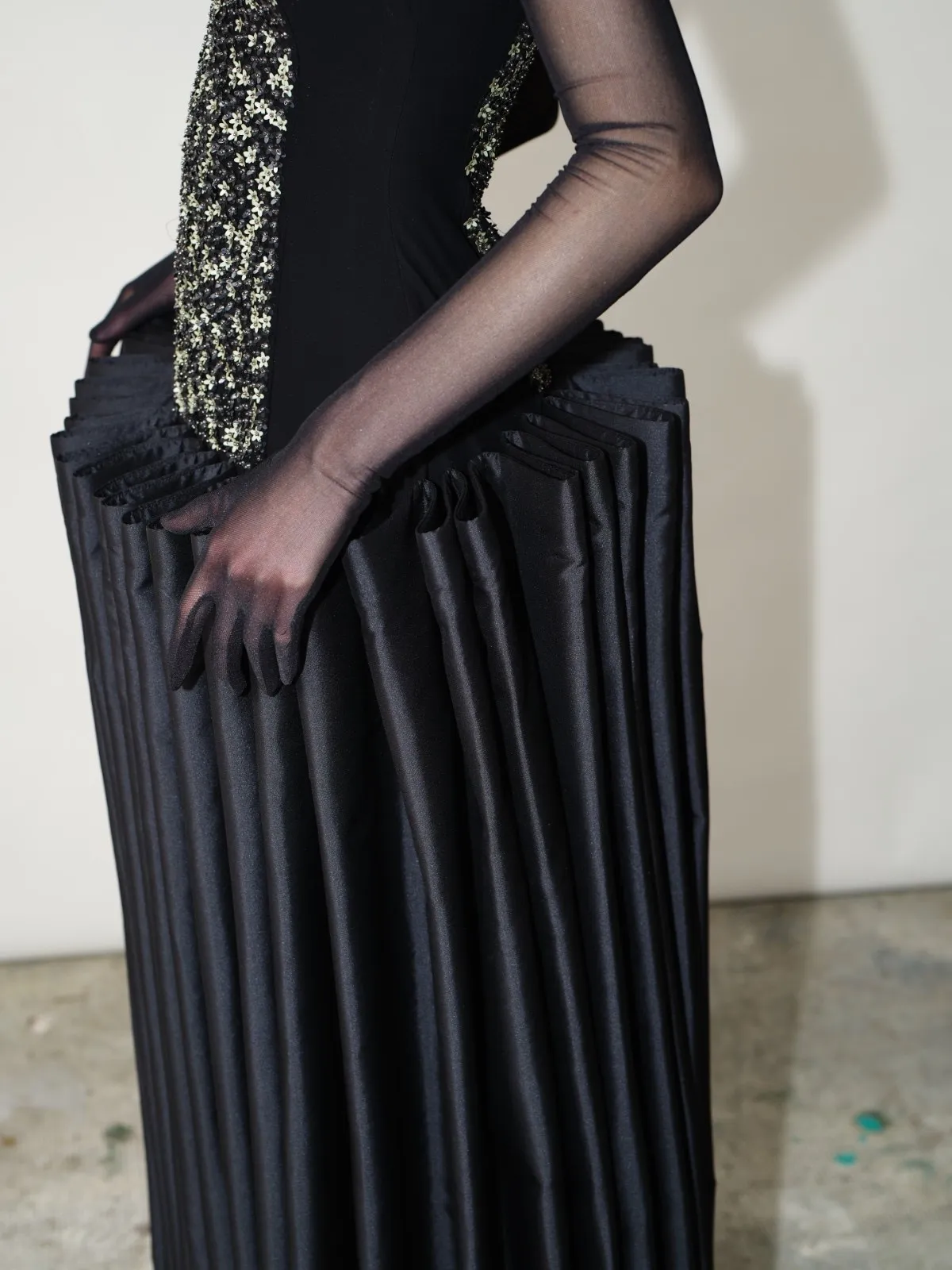 Black sculptural garment by Chorus featuring architectural hip volume and structured fabric folds
