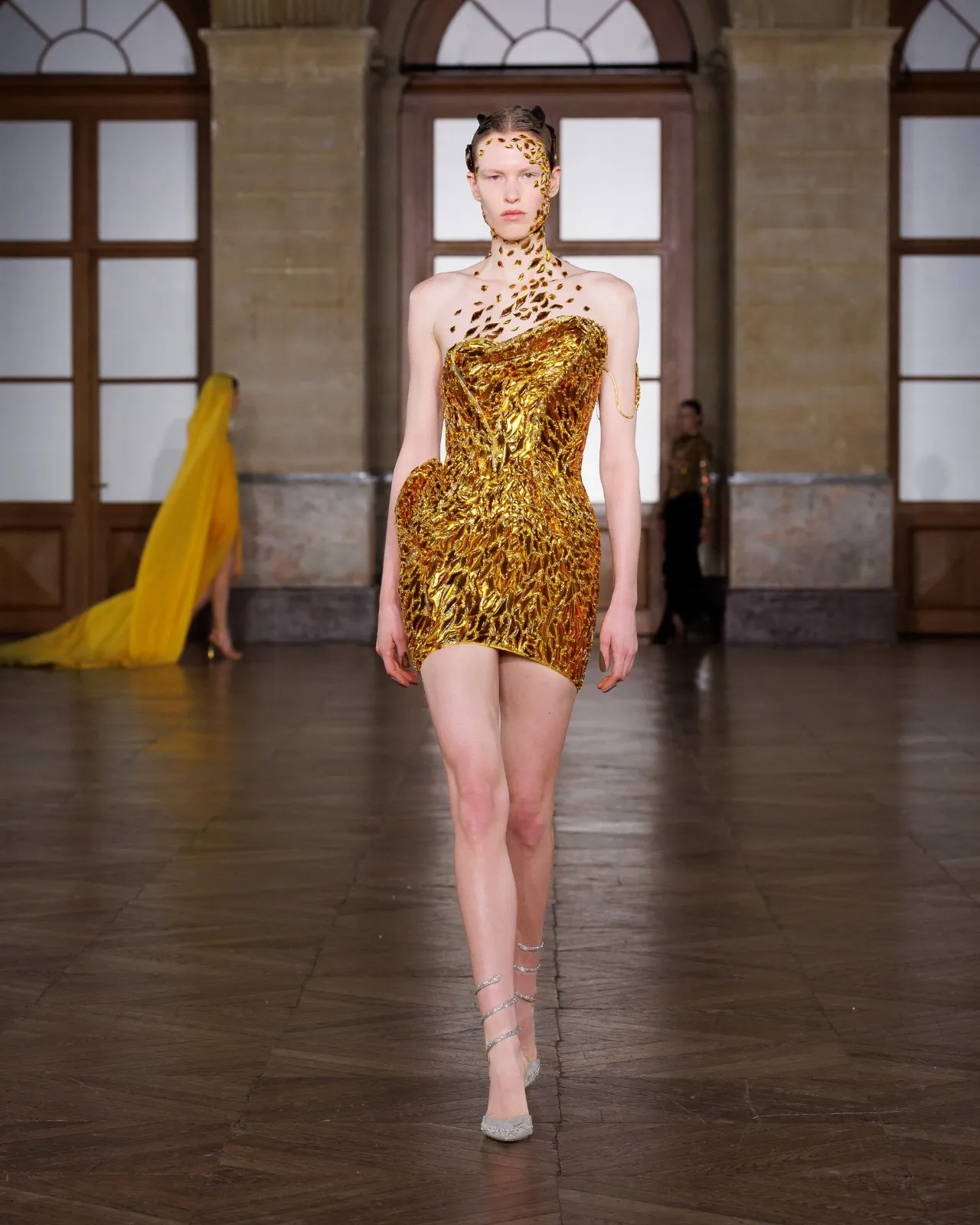 Model wearing a Gaurav Gupta corseted gown with exaggerated hip structure at Paris Couture Week