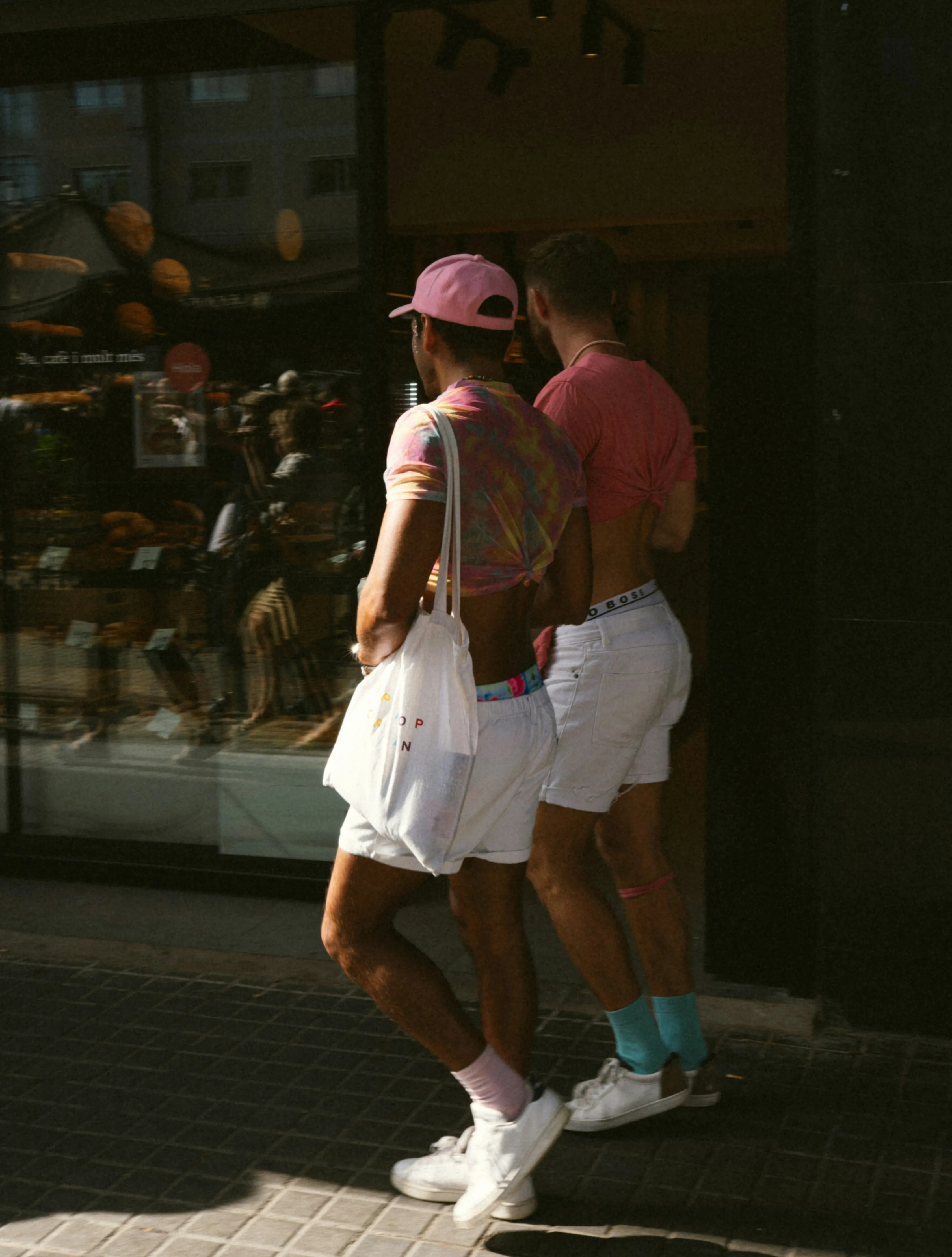 A queer couple in matching shorts to depict the romance, struggles and other nuances of queer late bloomer, the first queer relationship in adulthood and the first steps towards discovering sexuality as an adult