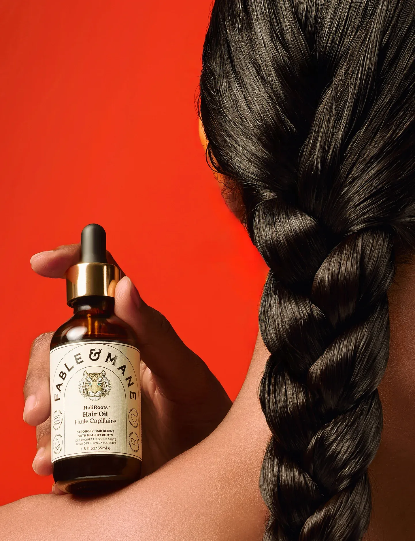 A backshot of a woman with the plate with a bottle of oil