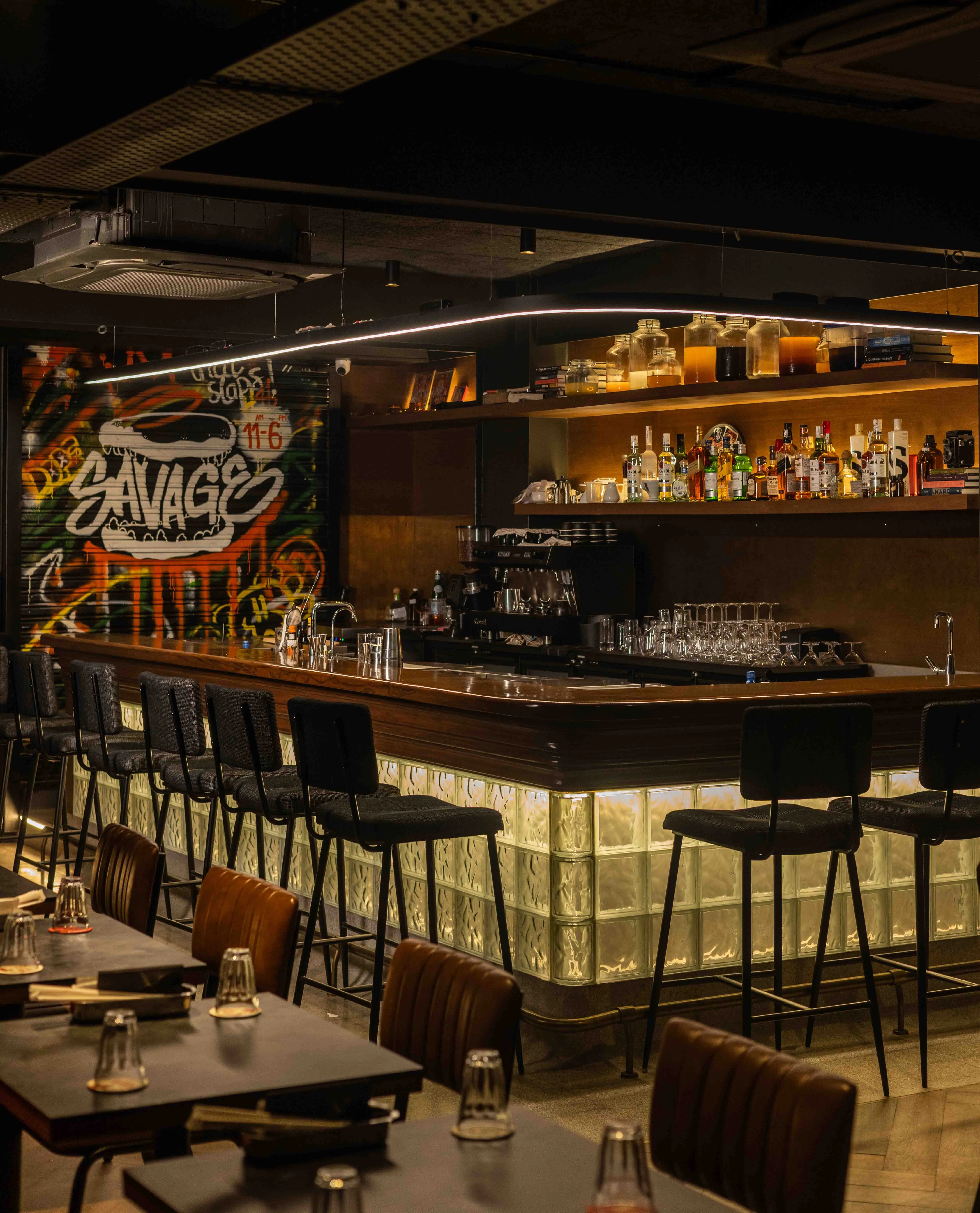 A picture of the bar Painkiller with the shutter of its cafe, shut, to show the evolution of cafe culture in India to have community spaces in India that cater to the crowd drinking alcohol as well as the crowd looking for more of a day time space