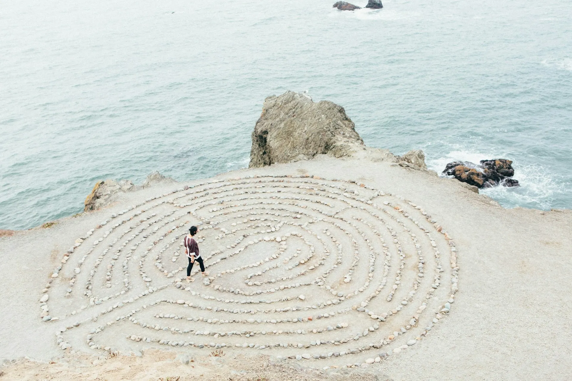 A picture of a man on a remote island with the brain's web on the sand