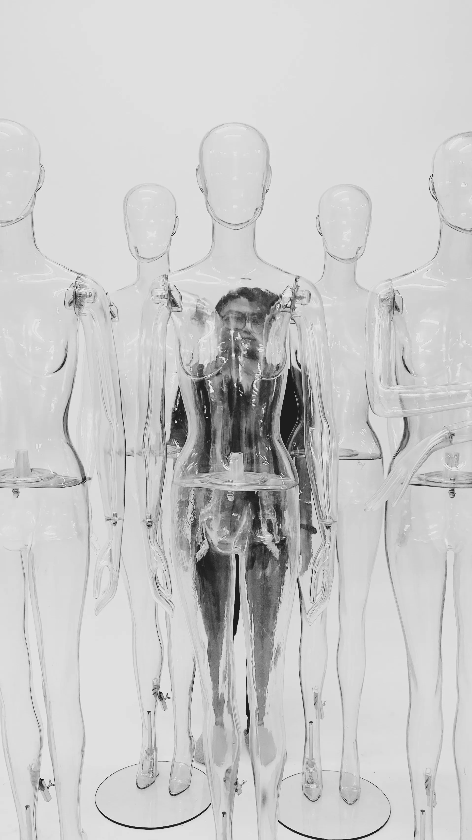 A black and white image of a human behind several creature of glass, reflecting a human seeking help of multiple mental health therapists in India