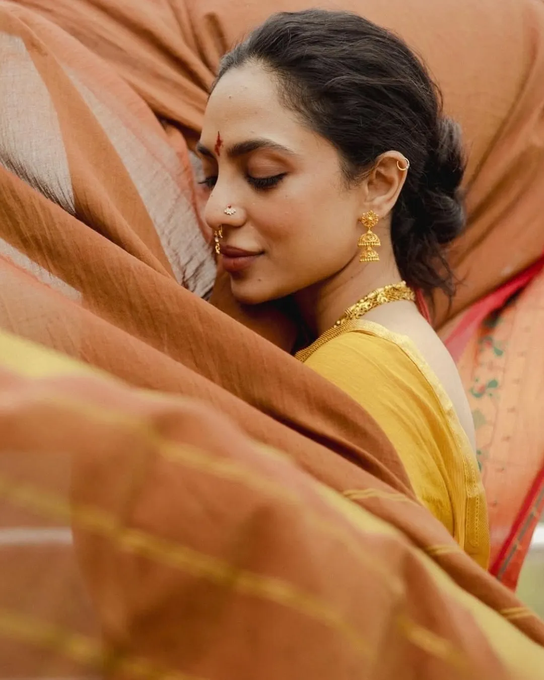 An image of Sobhita Dhulipala in a yellow sari
