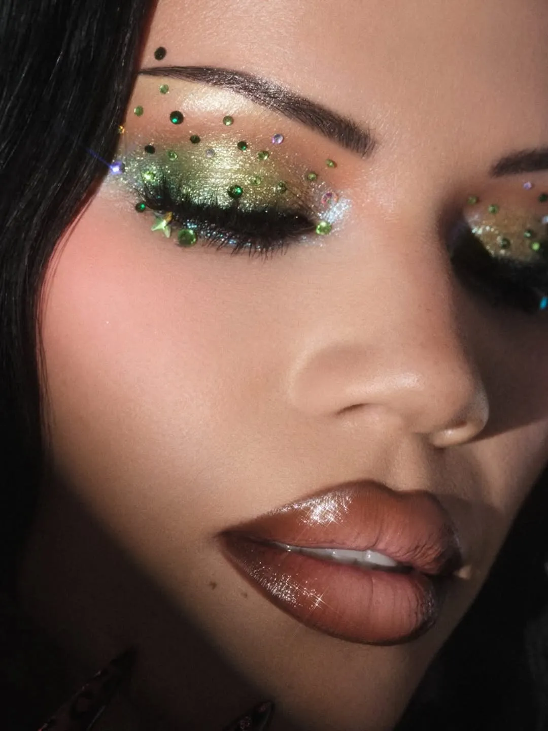 A female model with dramatic eye make-up with embellishments