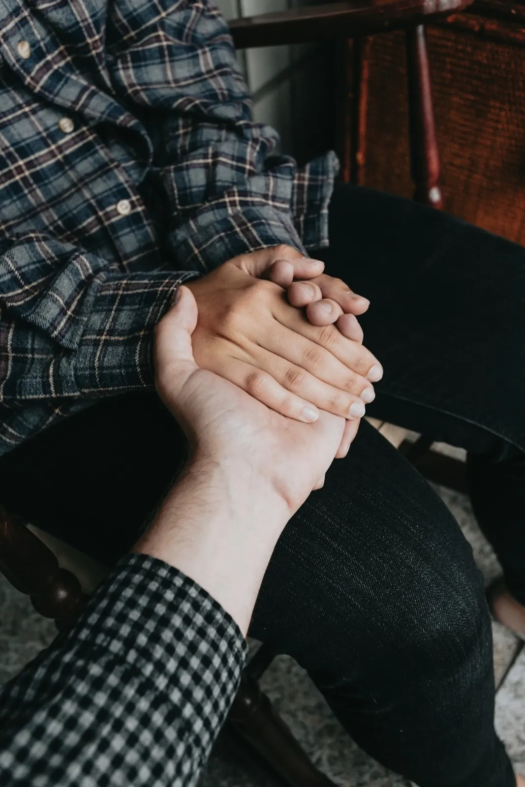 A picture of two people holding hands to show the benefits of crying with collective crying sessions as group crying therapy can help with urban loneliness in India and burnout in India as it acts like one of the stress relief activities in India
