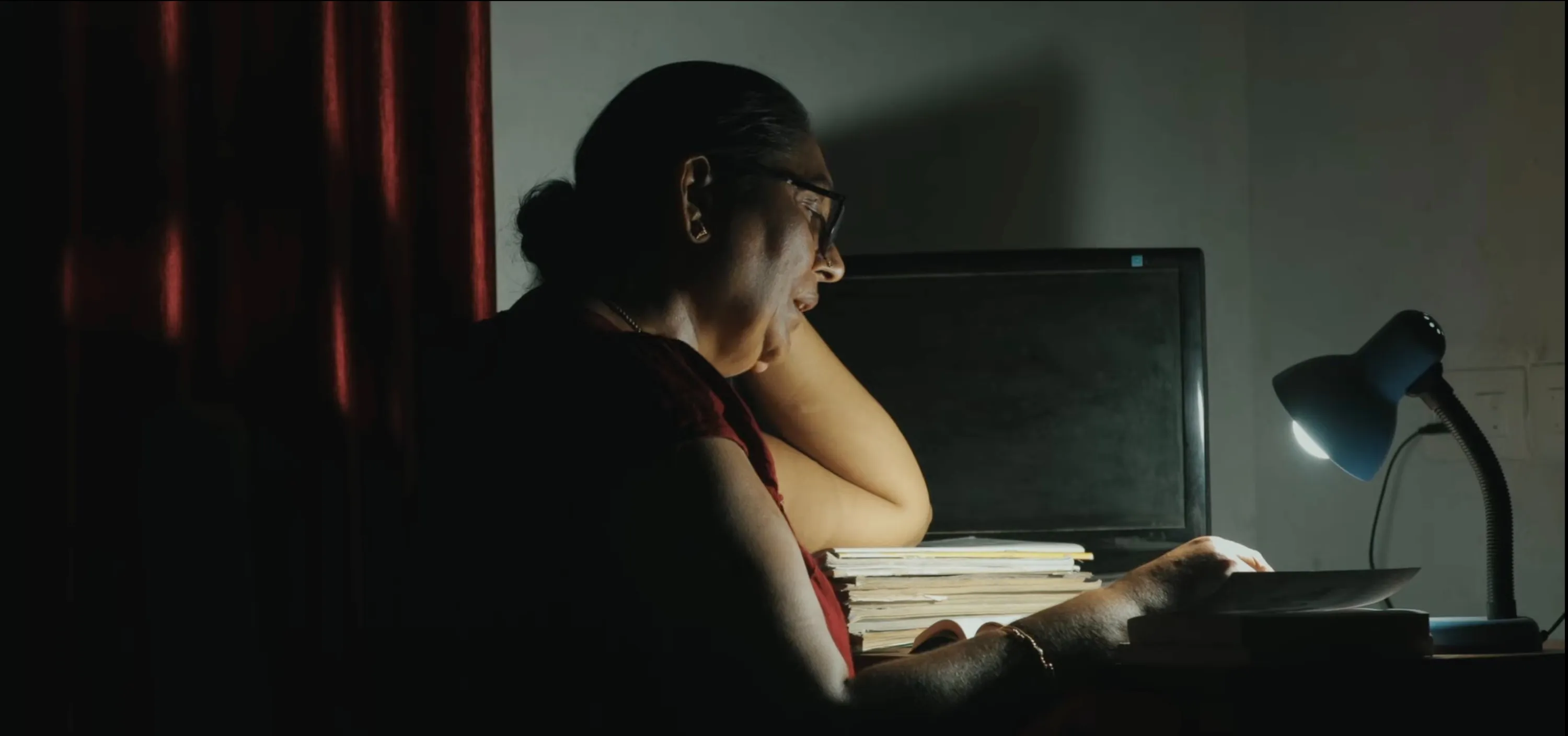 A still from P. Abhijith's I Am Revathi with Revathi sitting by herself in the frame to show how queer filmmakers in India are highlighting stories from the community via queer cinema India and queer film festivals India