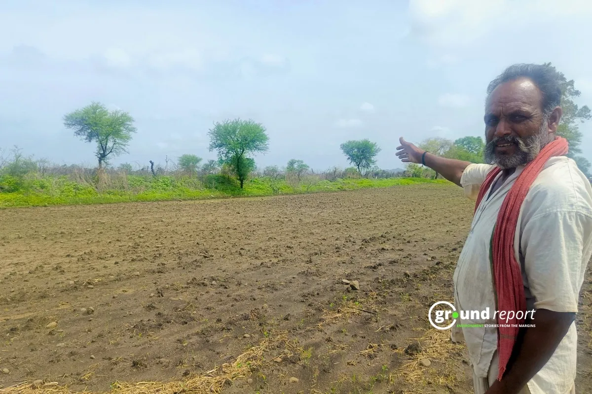 Farmer in Sarangpur showing us his farmland where his soybean crop destroyed