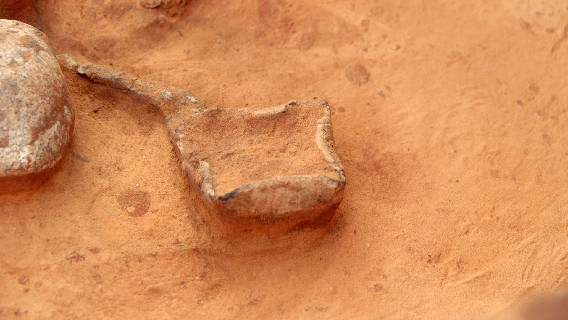 An oil lamp as discovered at the site. Photo by Emil Aljam, Israel Antiquities Authority