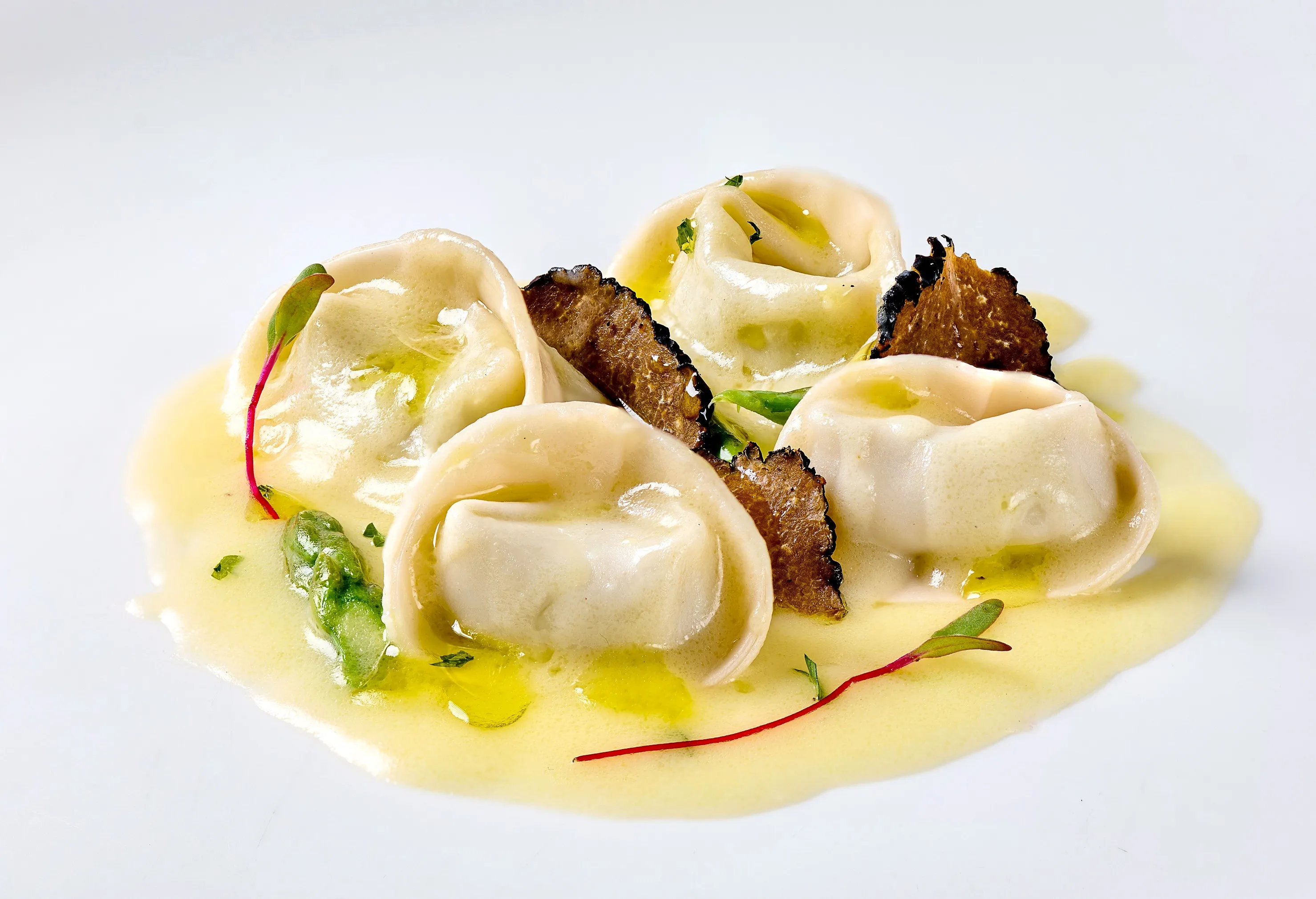 Tortelli stuffed with asparagus tossed in truffle scented white butter