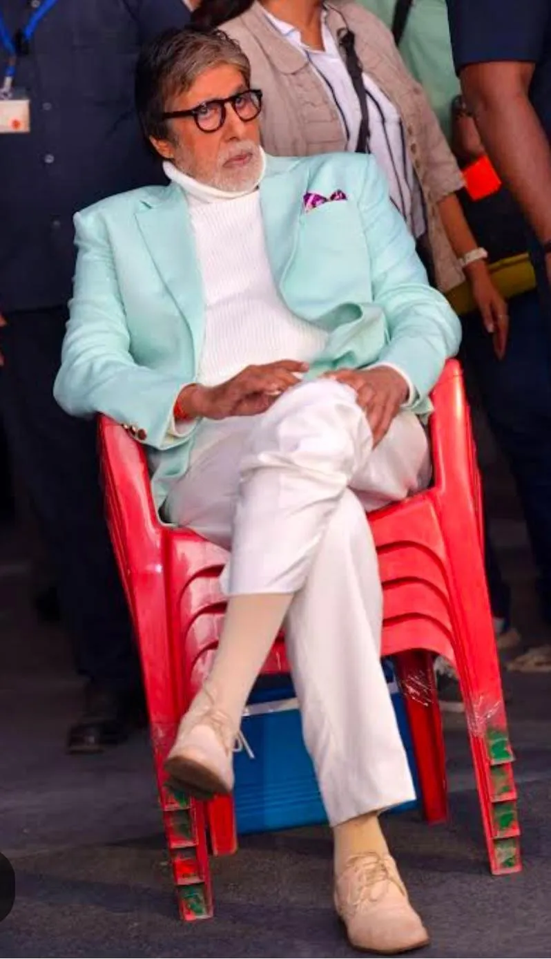Amitabh Bachchan sitting on 'multiple' ( 04) chairs